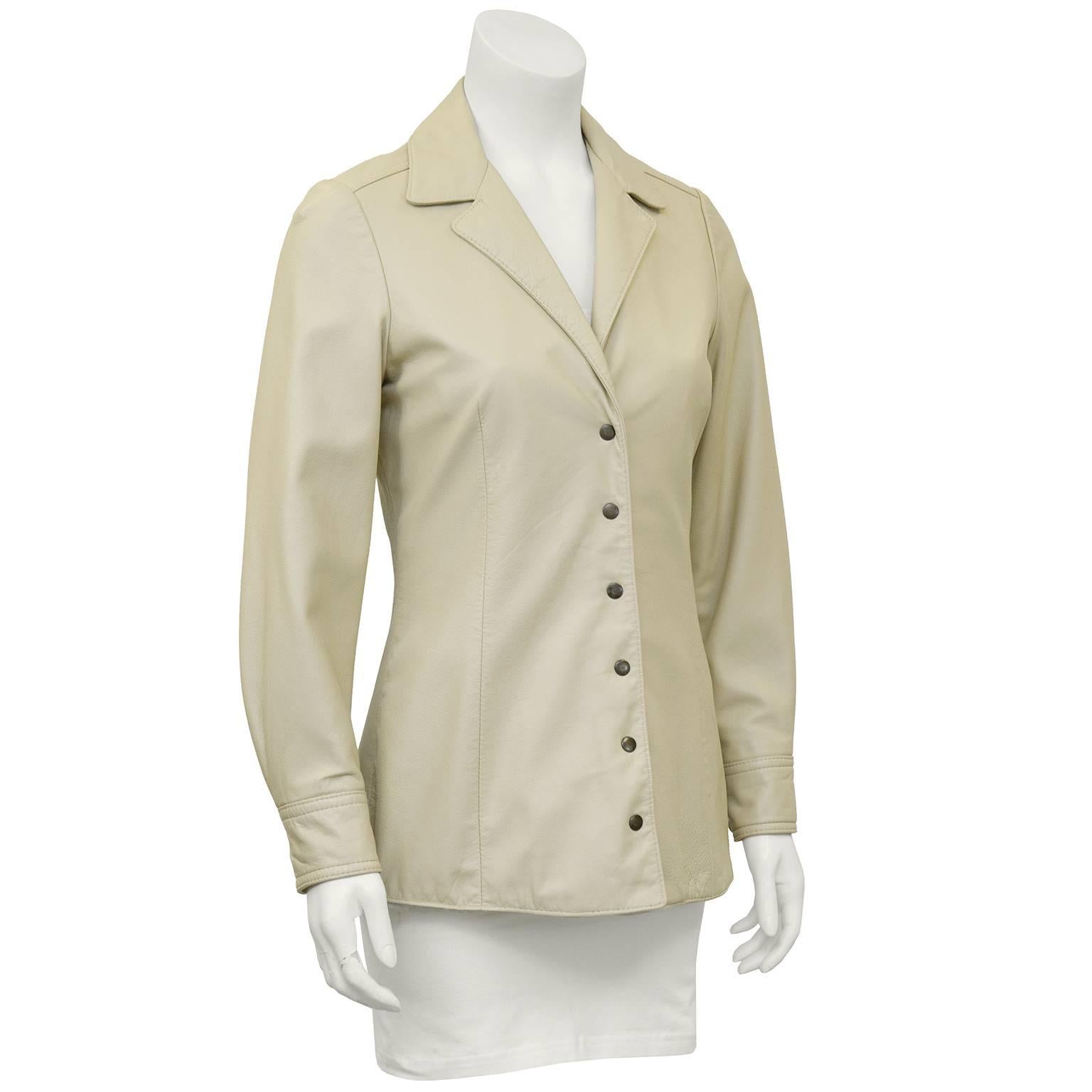 1970s Anne Klein beige leather jacket. Form fitting with snap closures. Seaming throughout gives it a beautiful shape. Lined in the matching beige satin. Excellent vintage condition. Fits like a US 4. 

Sleeve 17" Shoulder 32" Bust