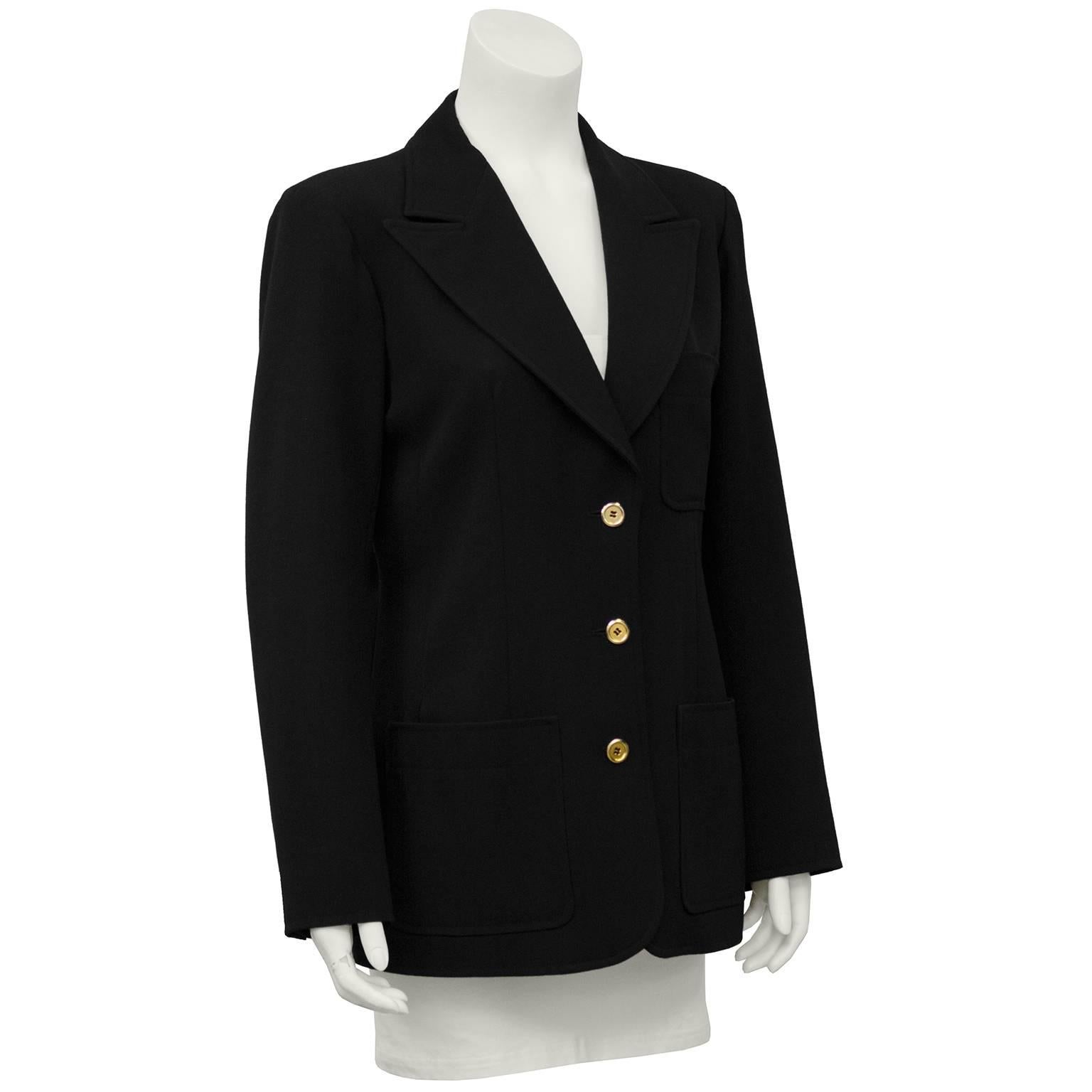 1970's Saint Laurent black gaberdine blazer. Small patch pocket at bust and 2 patch pockets at hips, 3 gold buttons. Classic and elegant, a piece you reach to wear again and again. Excellent vintage condition. Marked FR 44, fits like a US 6.