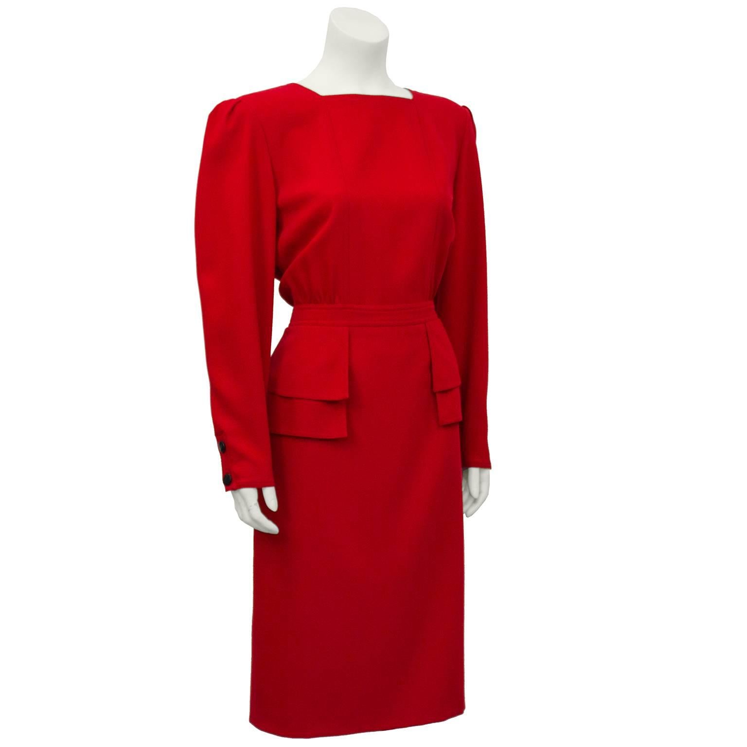 Classic 1980's Valentino red wool dress. Square neckline, details at waist and large (removable) shoulder pads. Valentino signature red dress appeared in every collection, in day and evening versions. Contrasting black buttons up the back and