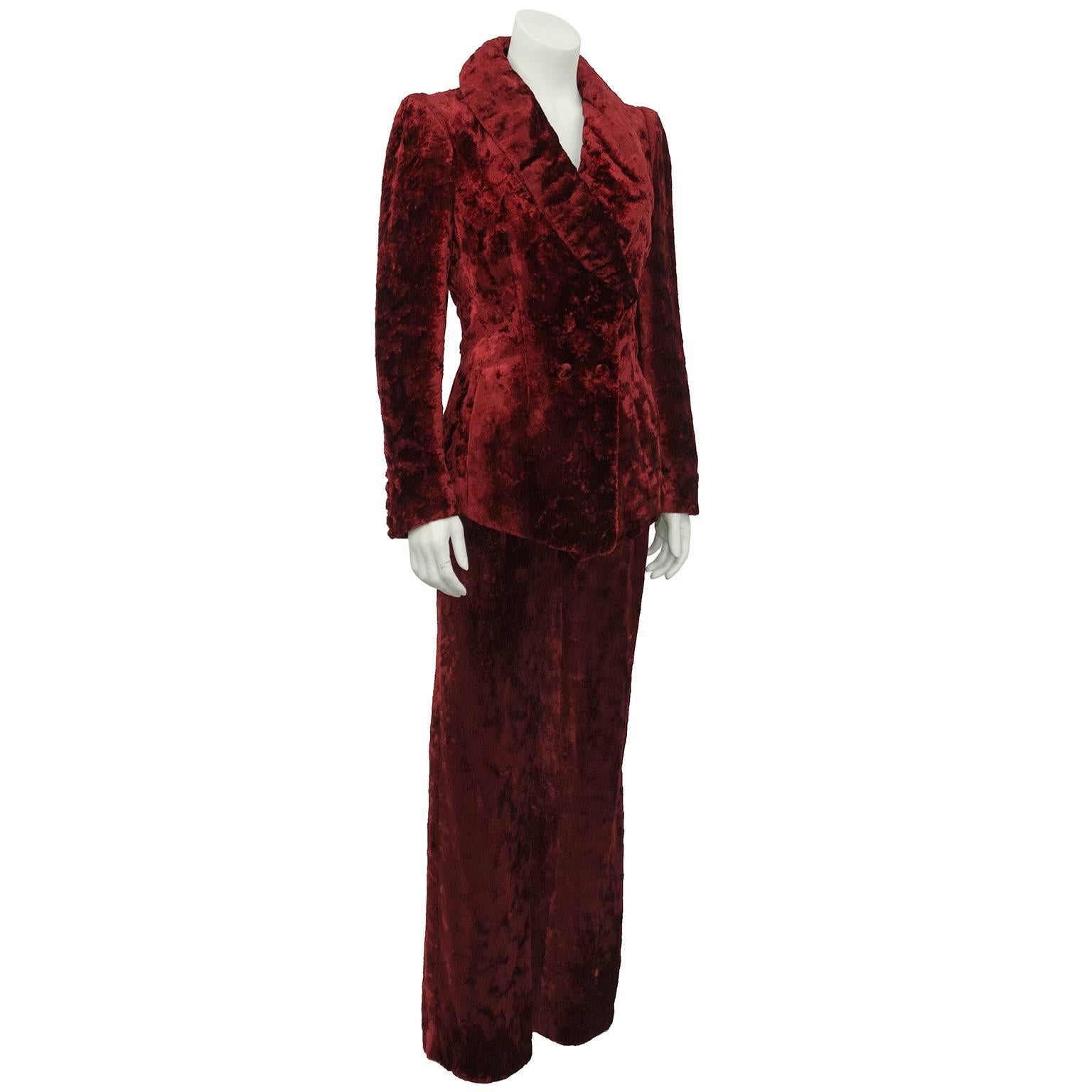 Sonia Rykiel crushed bordeau velvet suit dating from the 1980's. Double breasted jacket with oversized shawl collar. High waisted, straight cut trousers with pleats and belt loops allow option to wear pants with a white t-shirt and a belt. Very