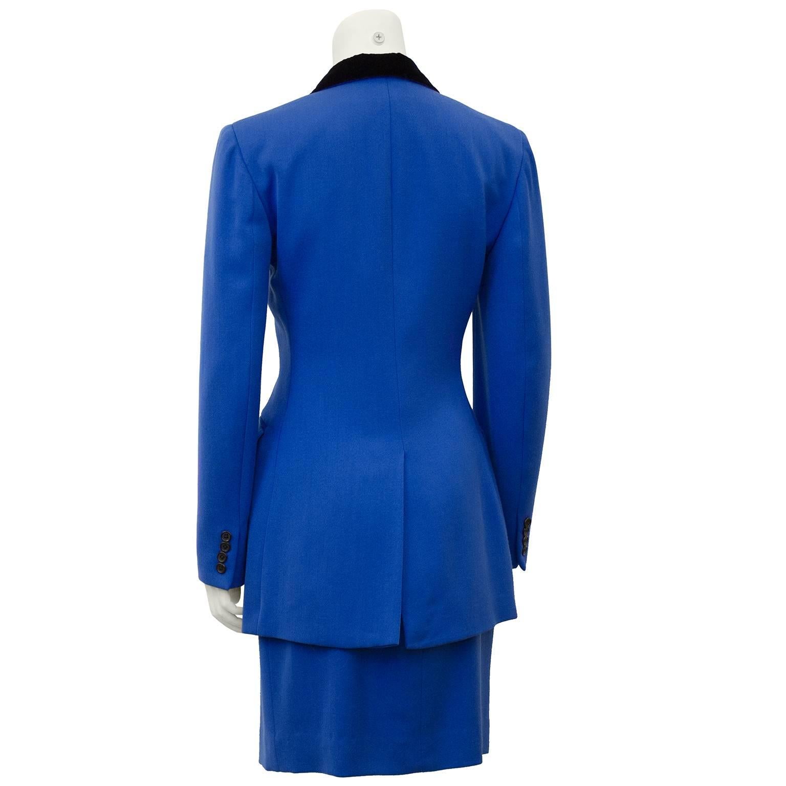 1980's Ralph Lauren equestrian inspired royal blue wool skirt suit. Double breasted, long,  fitted through the waist jacket with notched collar and jet black velvet upper collar. High waisted matching blue wool pencil skirt. Very Working Girl.