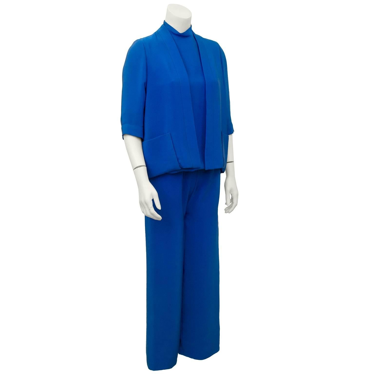 Darling minimalist and quintessential 1960's 3 piece silk ensemble from Normal Norell.  Jacket lis open cardigan style  with 3/4 sleeves and patch pockets. Tops is sleeveless with a mock neck and pants are cut straight and hit just above the ankles.