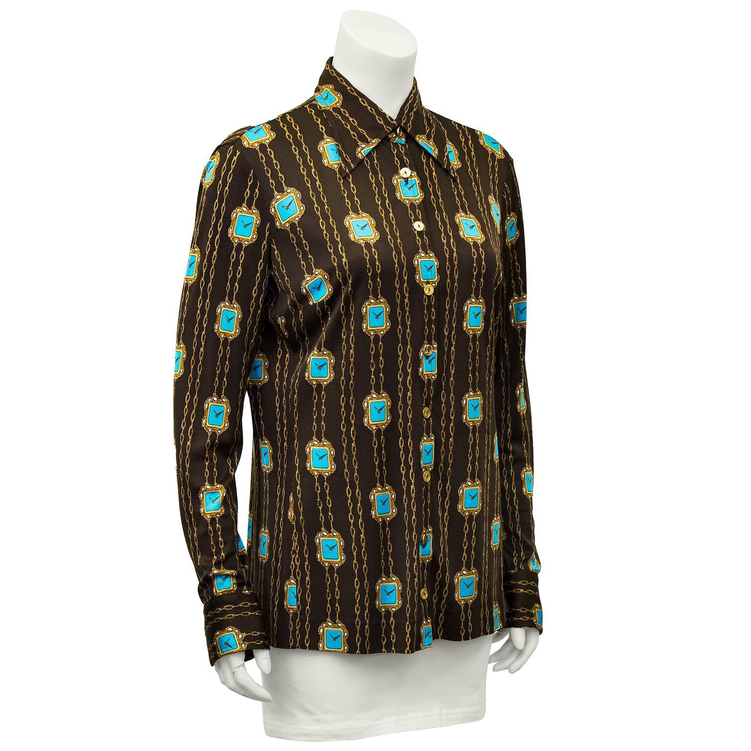 Anonymous 1970's polyester knit blouse. Brown with gold and turquoise chain trimmed clock pattern. Small gold buttons with L monogram could be attributed to Lancel. Excellent vintage condition. Fits like s US 4/6. 

Sleeve 19.5" Shoulder