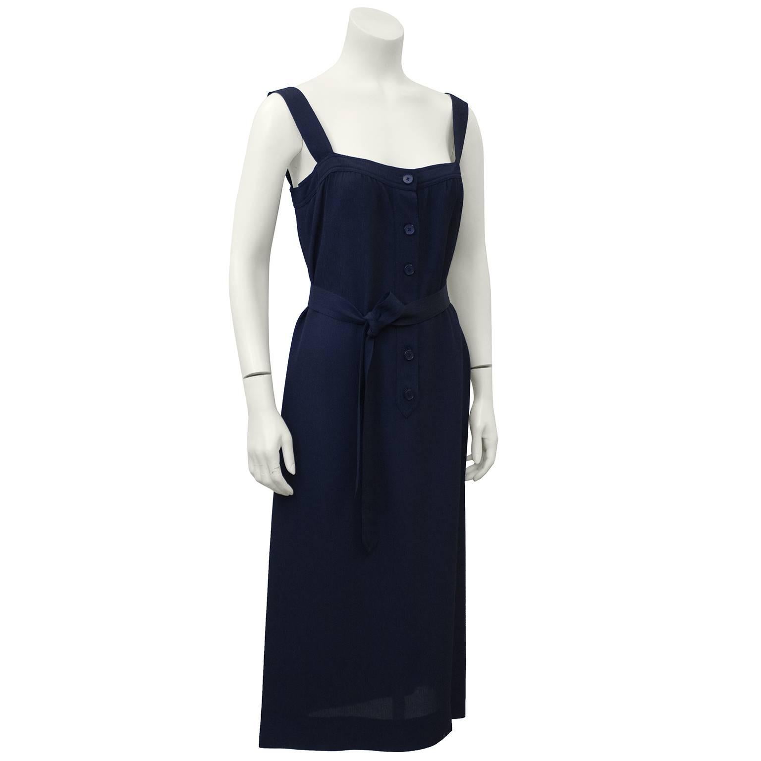 Early 1970's Givenchy Nouvelle label navy blue day dress. Square neck with tonal buttons down centre front. Optional belt that can be tied at waist to give the dress more shape or below bust for an empire look. Excellent vintage condition. Fits like
