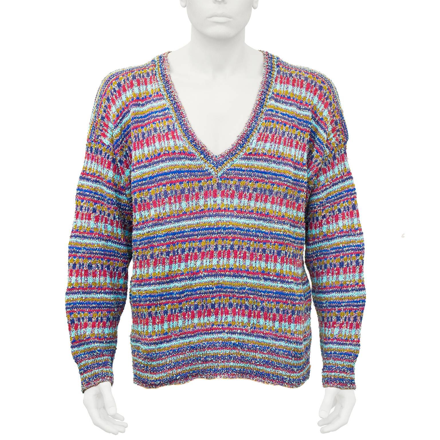 Classic vintage 1970's Missoni multi colored V-neck sweater in excellent condition. Knit in the iconic Missoni horizontal pattern combining reds, blues, turquoise and cafe coloured cotton blend yarns. Made for their mens collection but ideal for the