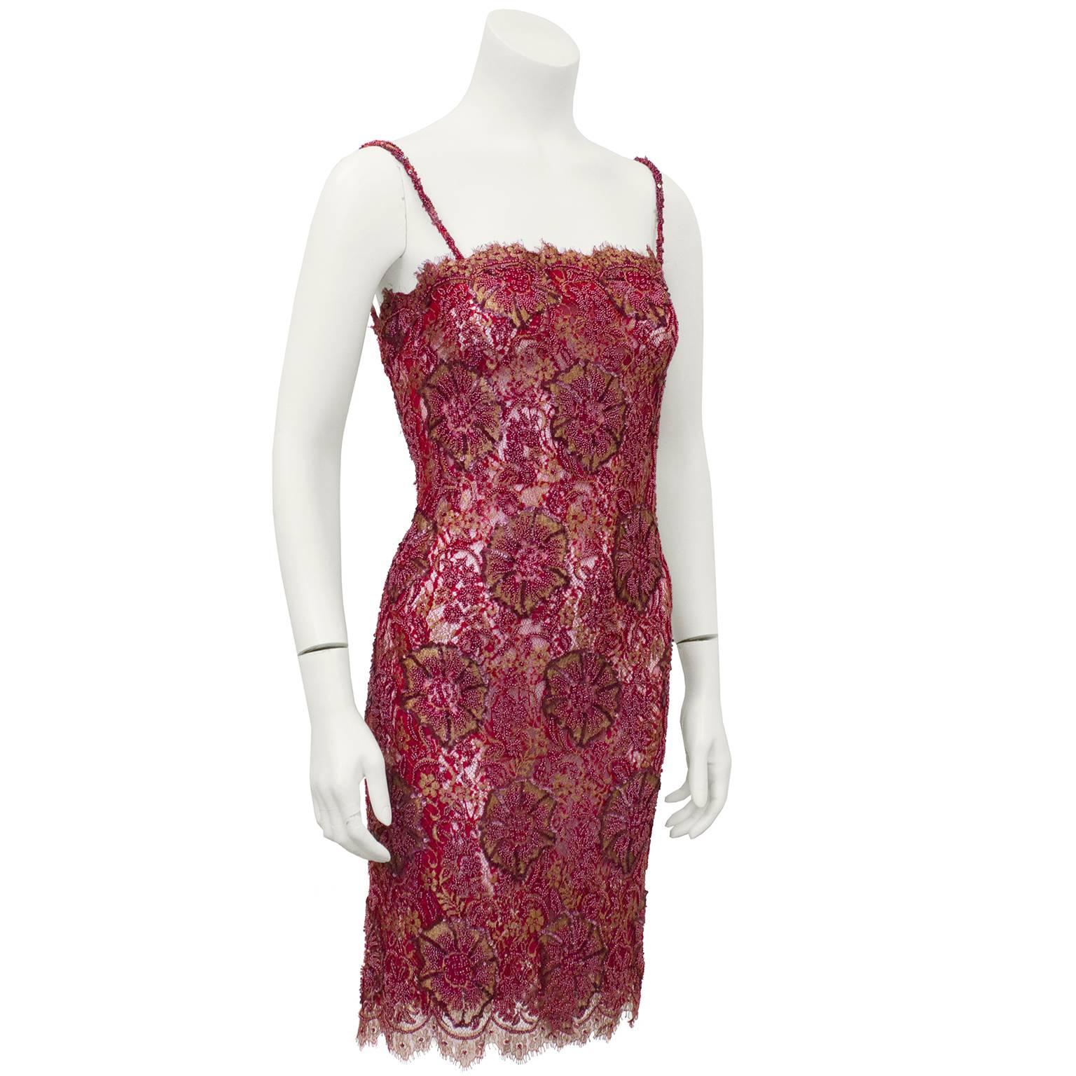 Exquisite anonymous 1960s cranberry and gold red lace demi couture cocktail dress featuring an exquisite floral lace design with hand beading and gold metallic thread embroidery. Unbelievable attention to detail causes larger flowers throughout to