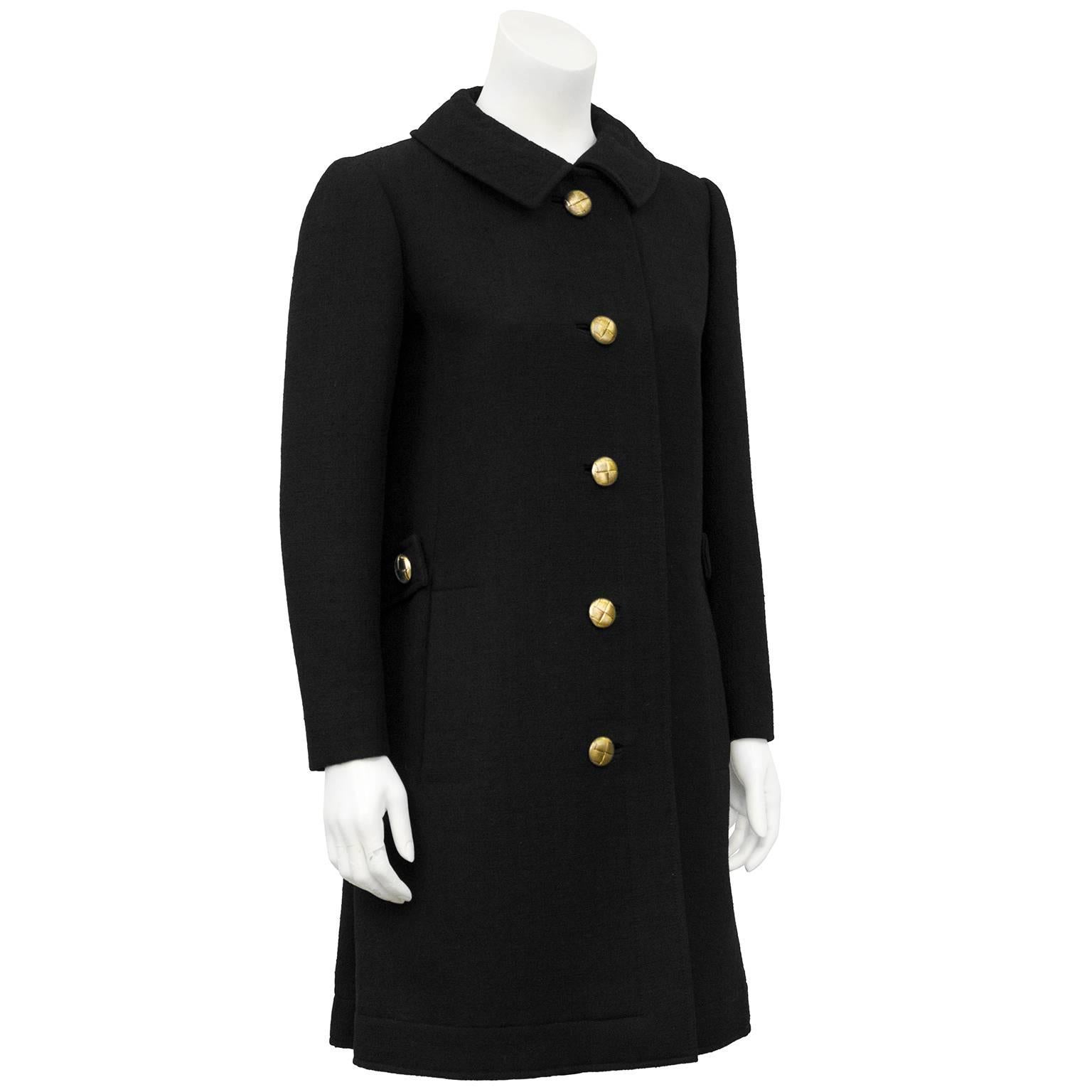 Lanvin black wool 3/4 length coat circa the 1960's. Features include a peter pan collar, brass tone quilted buttons, side vertical stripe pockets and a half back belt. Beautiful draping with inverted pleats at back. Brown silk lining. Fits like a US