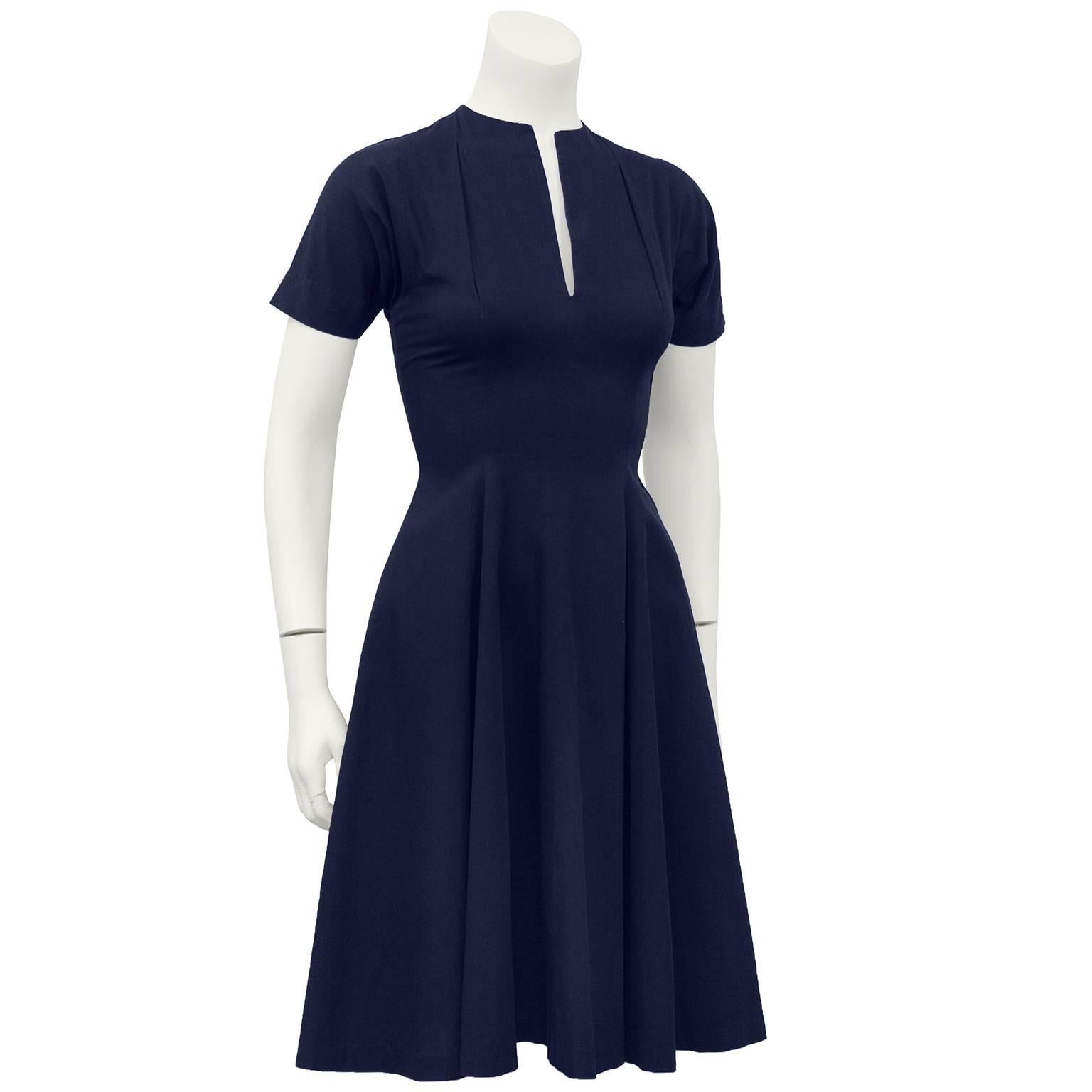 1950s' navy blue Claire McCardell cotton fit and flare dress. Fitted bodice with short sleeves, narrow v neckline, inverted darting above bust and flared a-line skirt. Very classic hard to find, Claire McCardell. Fits like a US 2 - very narrow