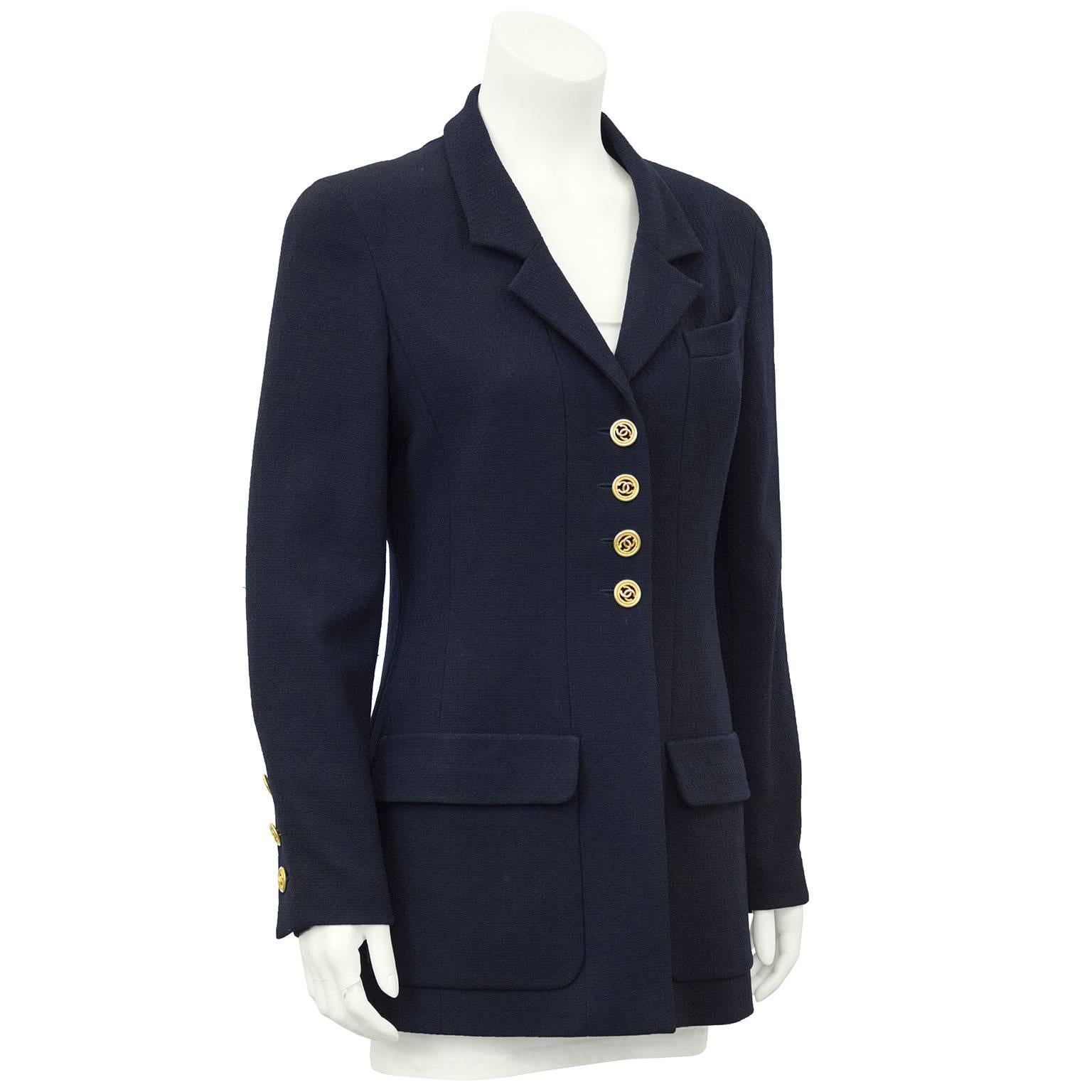 Classic 1990s Chanel navy blue wool blazer. Narrow collar, gold Chanel logo buttons at bust and cuffs and oversized patch pockets. Lined in black silk. Fits like a US 6. Excellent vintage condition.

Sleeve 22" Shoulder 20" Bust 36"
