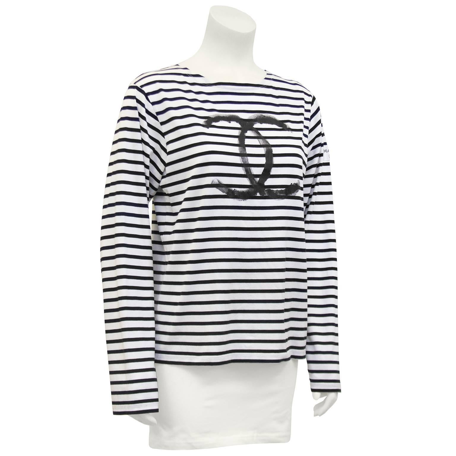 Limited edition white with black horizontal stripes cotton long sleeve shirt from the Chanel 2008 Christmas collection. Large black hand painted CC logo on front. Chanel tag patch on left sleeve. Made in Italy. Size S, but fits more like a M/L. Seen