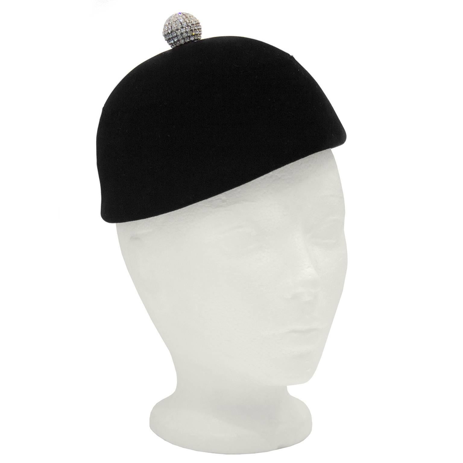 Absolutely stunning 1950's Givenchy jet black minimalist style velvet jockey hat with a small rhinestone incrusted pom pom at the top. This piece shows the stunning simplicity of the early Givenchy work with the attention to detail and beautiful