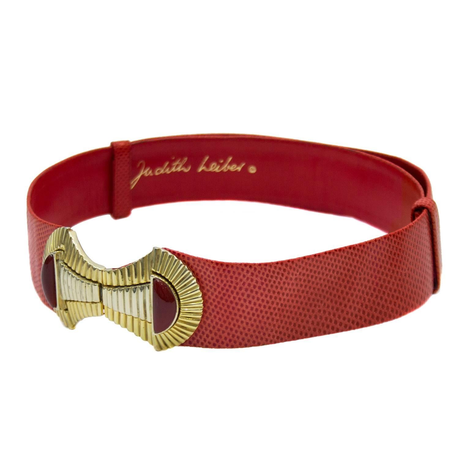 1980s red lizard Judith Leiber adjustable belt. Large gold and silver tone buckle with hook closure. Interior gold brand stamp. Excellent vintage condition. 39" at loosest, 30" at tightest. 
