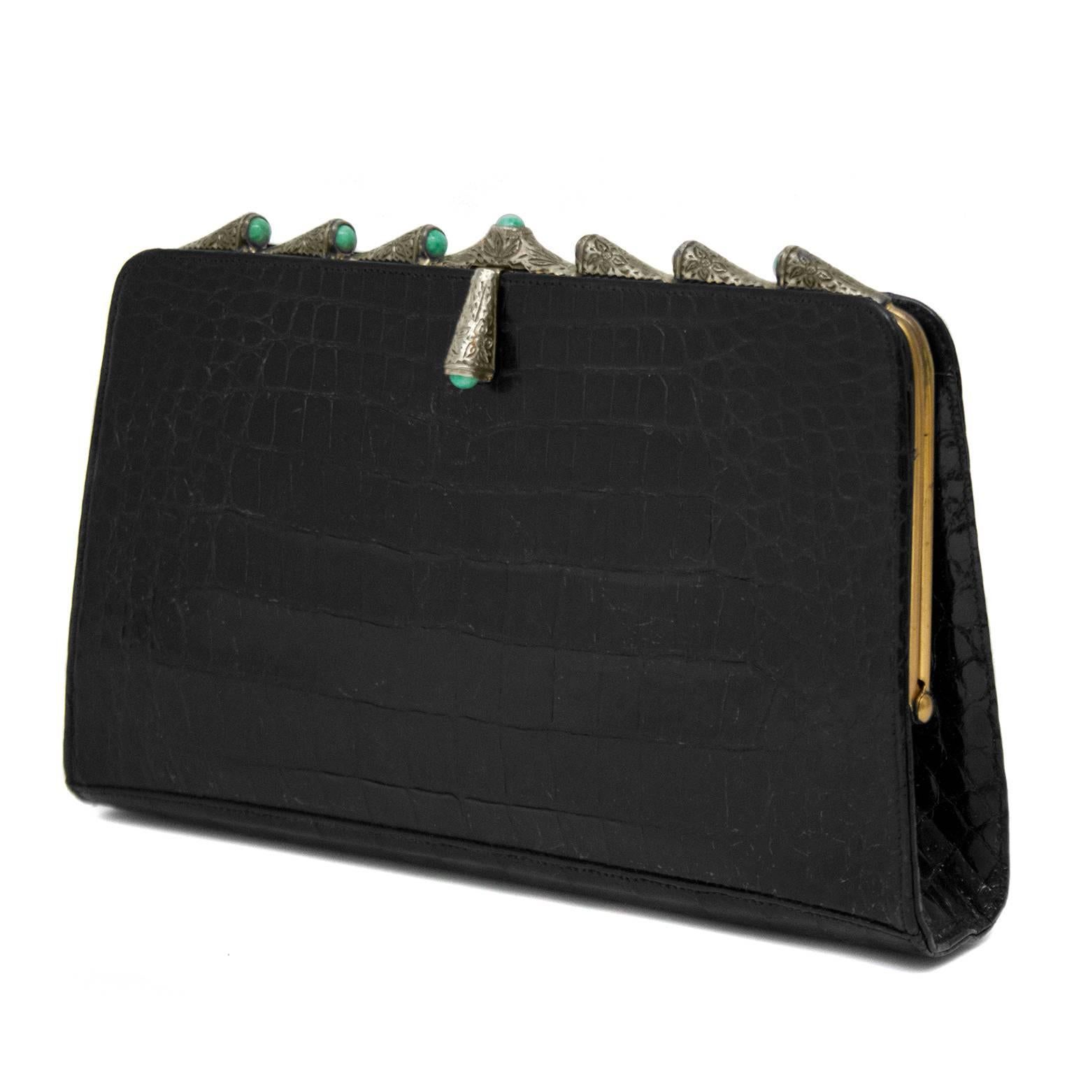 Elegant 1950s black crocodile skin evening clutch featuring etched silver details with turquoise stones. Gold hardware. Leather interior with one small slit pocket. Fits an iPhone. Small handle on back. 

Length 9.2" Height 6" Depth