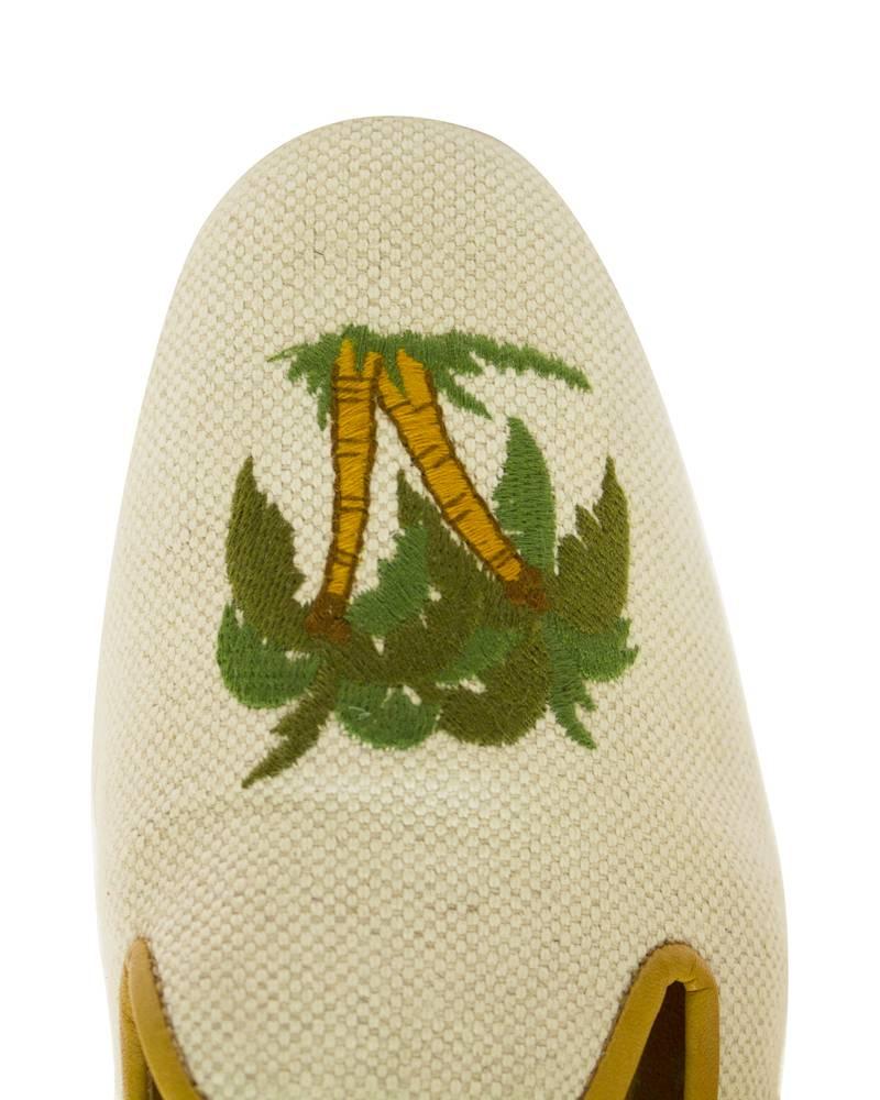 Perfect for Palm Beach, these Stubbs & Wootton woven slippers have embroidered palm trees on the toes and are trimmed with a light brown leather. Minimal signs of wear on the sole, in overall excellent condition. Marked US 8 AA, very narrow.
