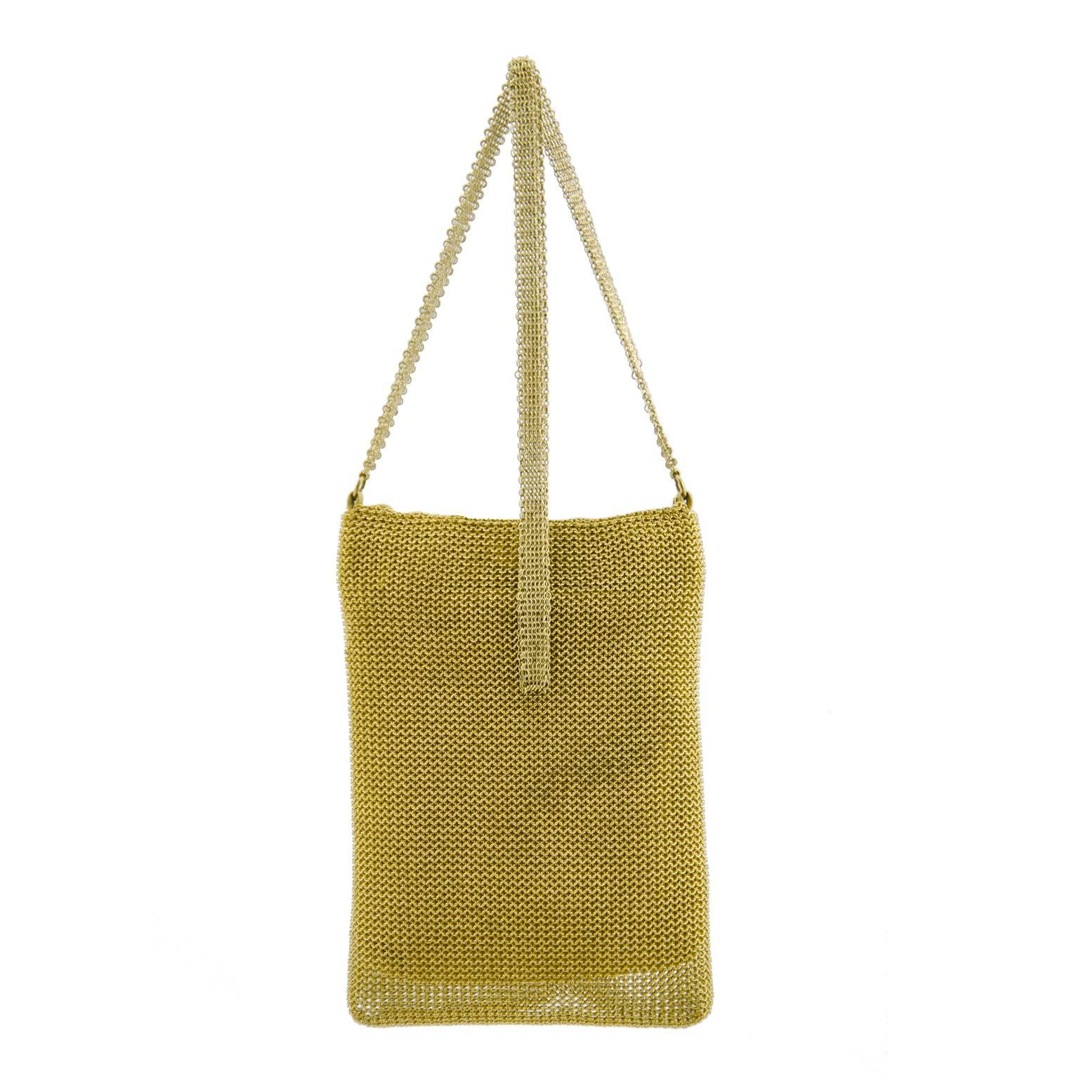 Gorgeous 1950s gold mesh chain link bag with a fold over flap. Medium length strap, could be worn cross body depending on your size. Snap closure and gold interior lining. In excellent vintage condition, light marking throughout interior. Overall a