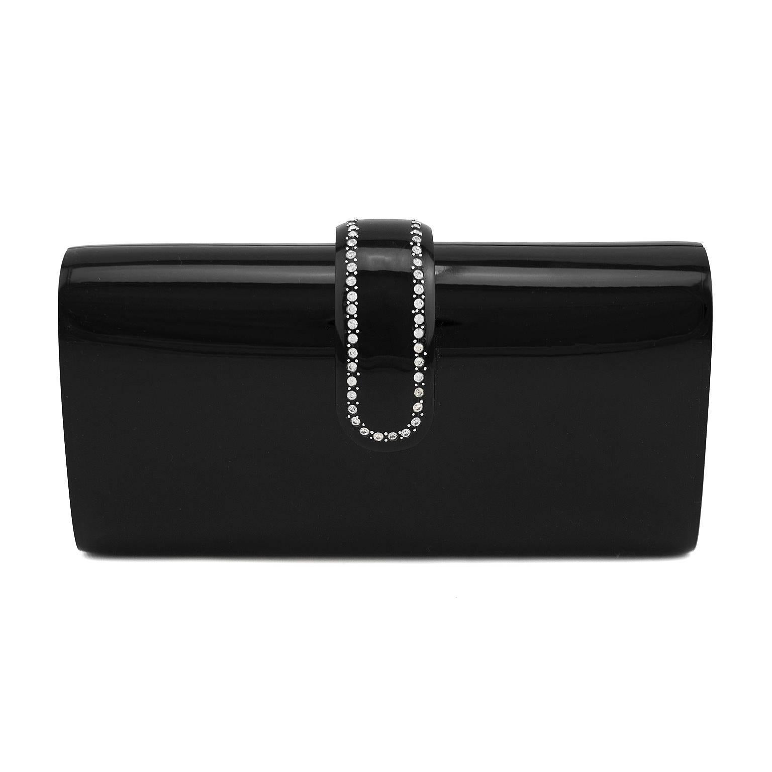 Elegant and sleek 1960s black resin rounded rectangle evening clutch. Interesting swivel claw closure, embellished with rhinestones. Clean black velvet interior. Fits an iPhone. Excellent vintage condition. Perfect for the holiday season, dinner and
