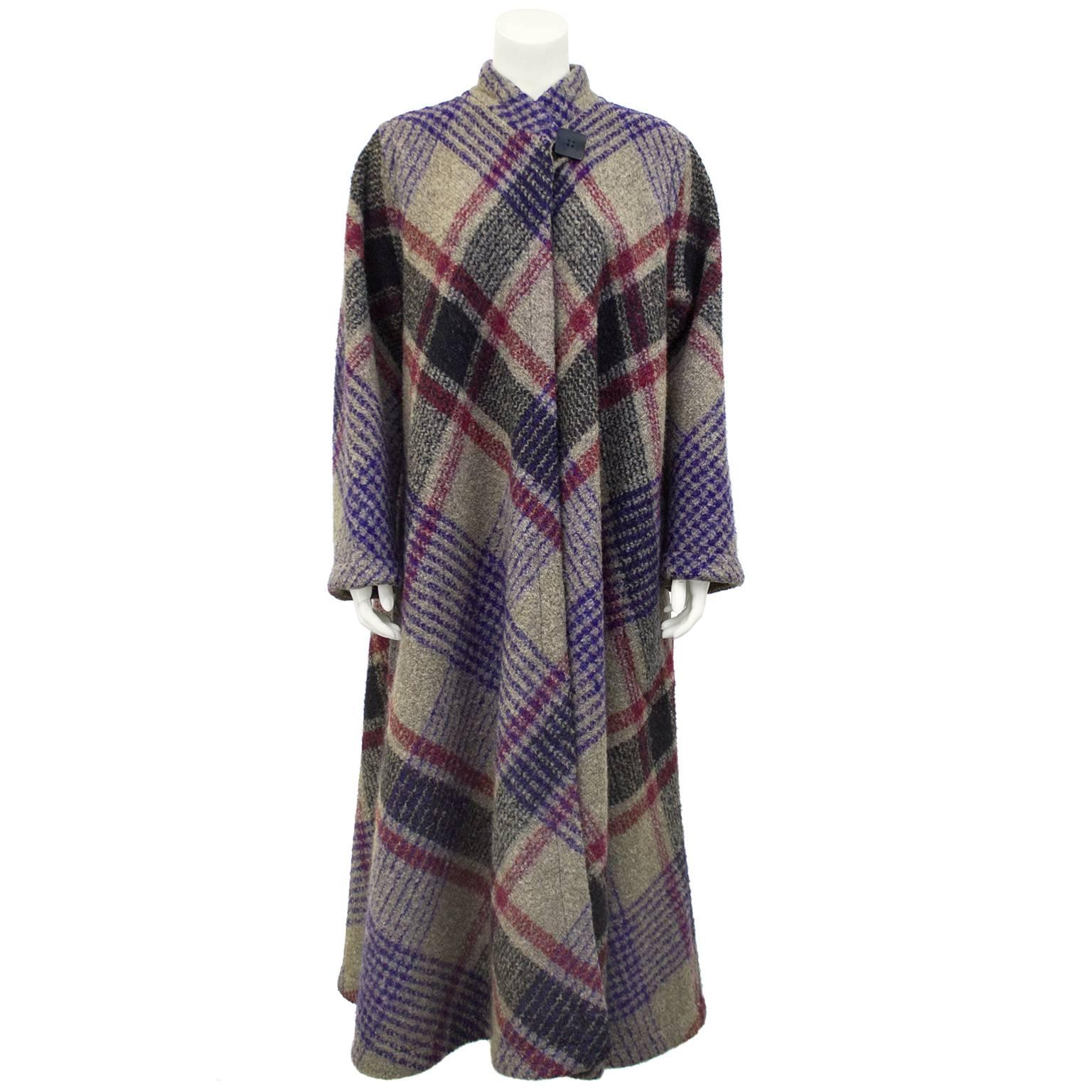 1970s Missoni long wool coat featuring a grey, black, purple and red diagonal tartan. Singular black black square button closure at neck. Unlined. Excellent vintage condition.  Fits from US 4-10.

Sleeve 23