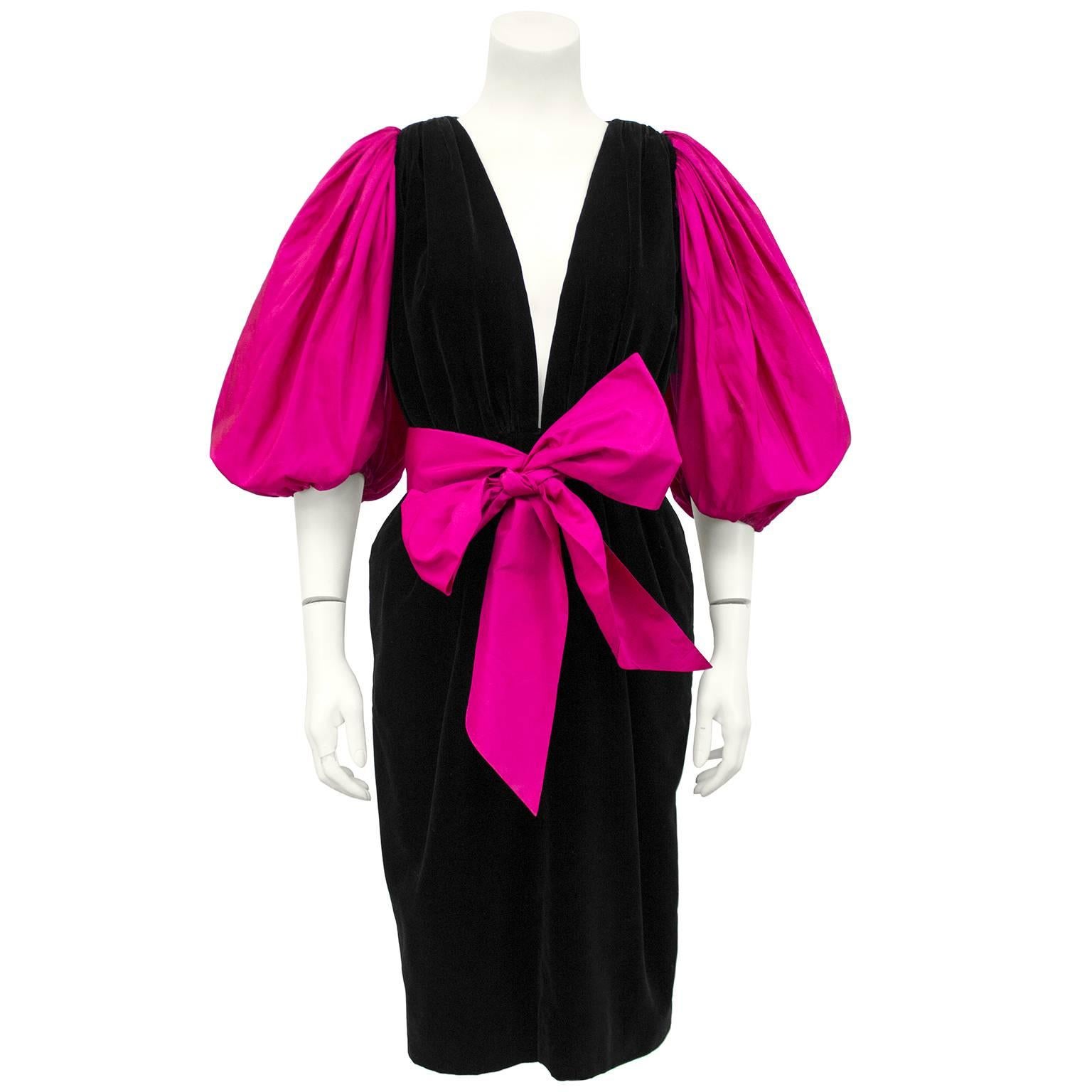 1980s YSL/Yves Saint Laurent jet black velvet cocktail dress. Extremely deep v neck with fuchsia silk taffeta balloon sleeves and large bow detail at waist. Excellent vintage condition. Marked FR 38, Fits like at US 4.   

Sleeve 19