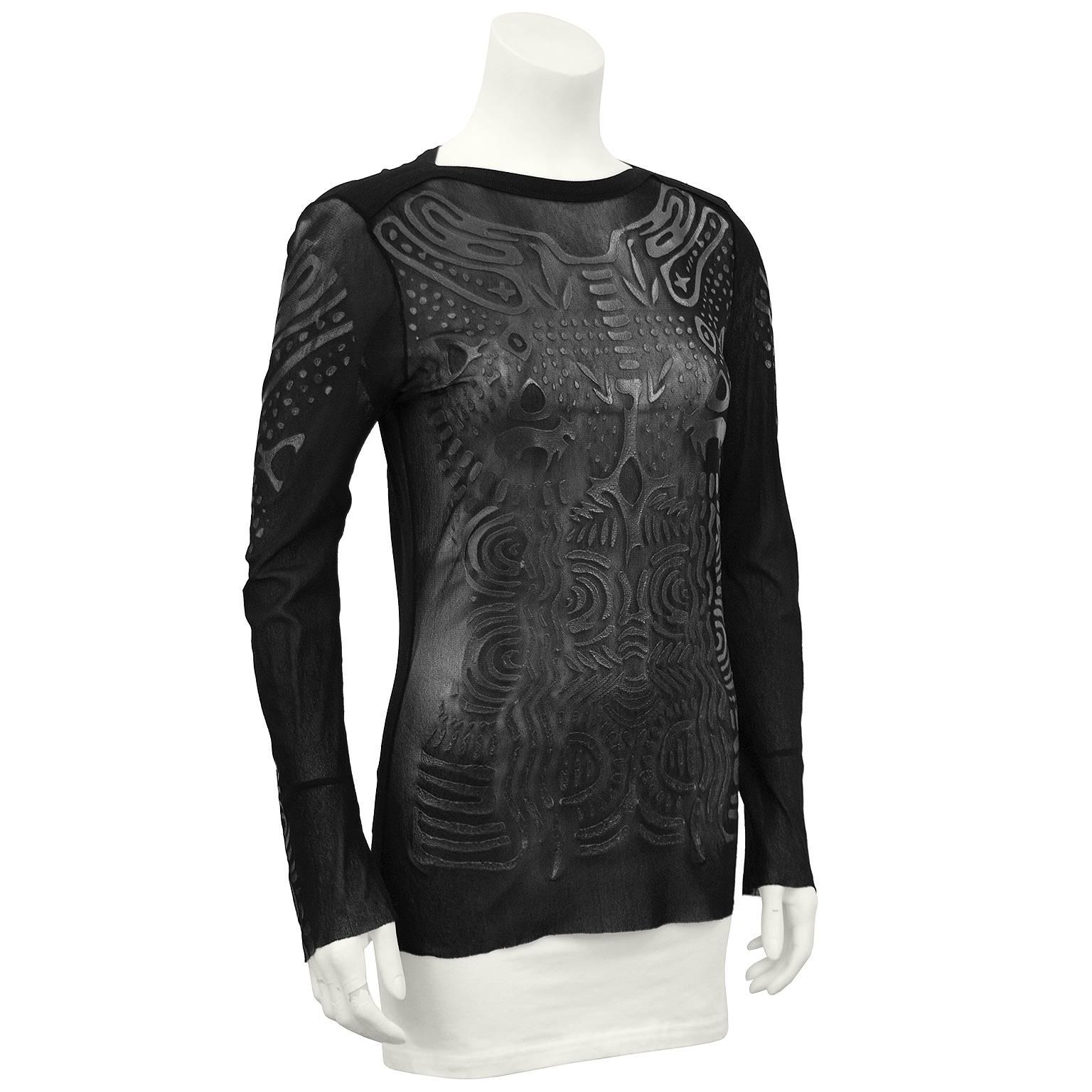 1990s Jean Paul Gaultier black sheer long sleeve top. Sheer with monochromatic black screen printed abstract shapes that resemble tattoos when wearing. Excellent vintage condition. Fits like a US 4. 


Sleeve 21" Shoulder 18" Bust 35"