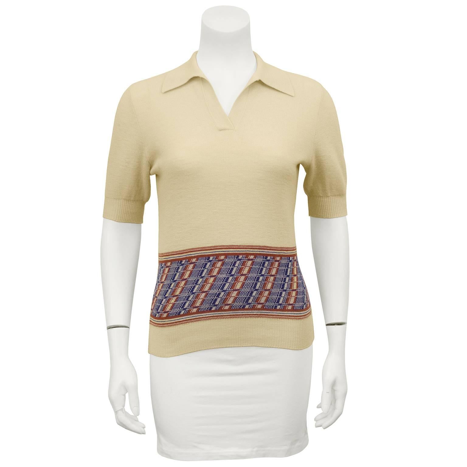 Super cute 1960s Gucci wool knit polo. Cream with blue and rust pattern at hips. Open collar with no buttons. Ribbing at sleeves and hem. Excellent vintage condition. Fits like a US 2-4. 

Sleeve 10" Shoulder 18" Bust 33" Waist