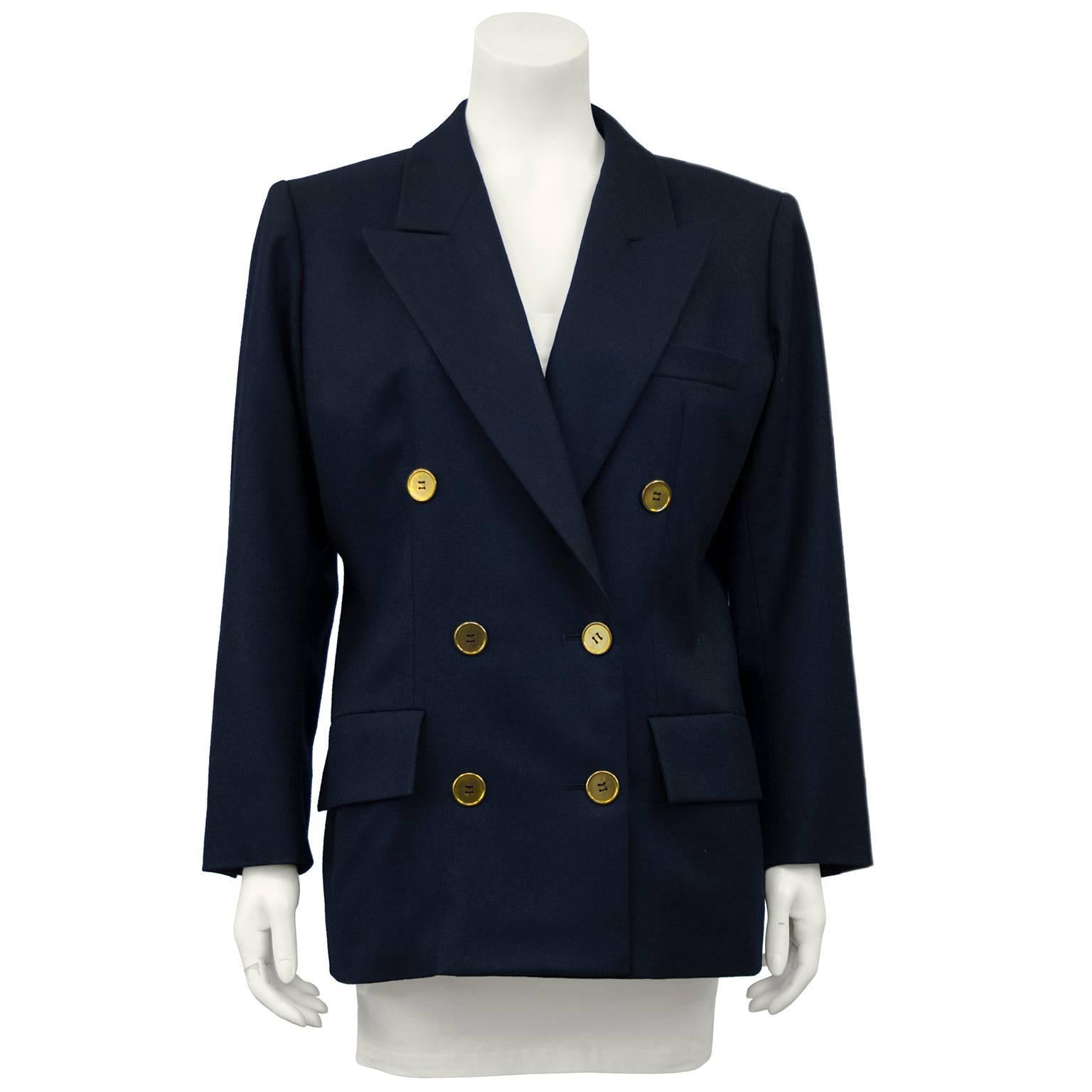 Early 1980o's double breasted YSL blazer in navy wool gabardine with gold tone buttons. Classic styling with some YSL emphasis on the shoulder. Size 44 Fits like a US 8. In excellent condition with no signs of wear.