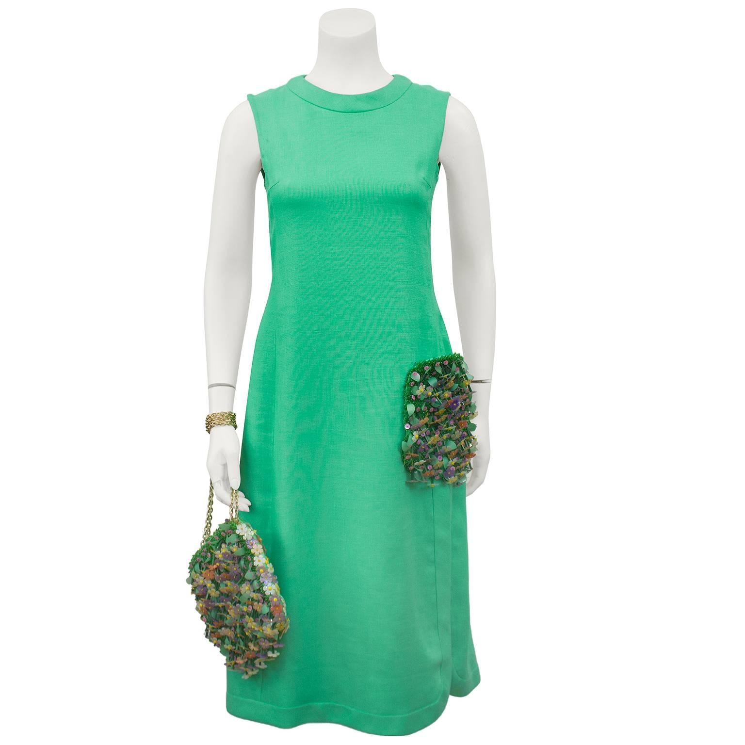 Canadian couturier Maggy Reeves spring green linen dress from the 1960s. Chic and simple sheath style dress with vertical seams down the body, tie at back/waist and zipper up the back. Accented with fabulous 3-D hand beaded side hip pocket and