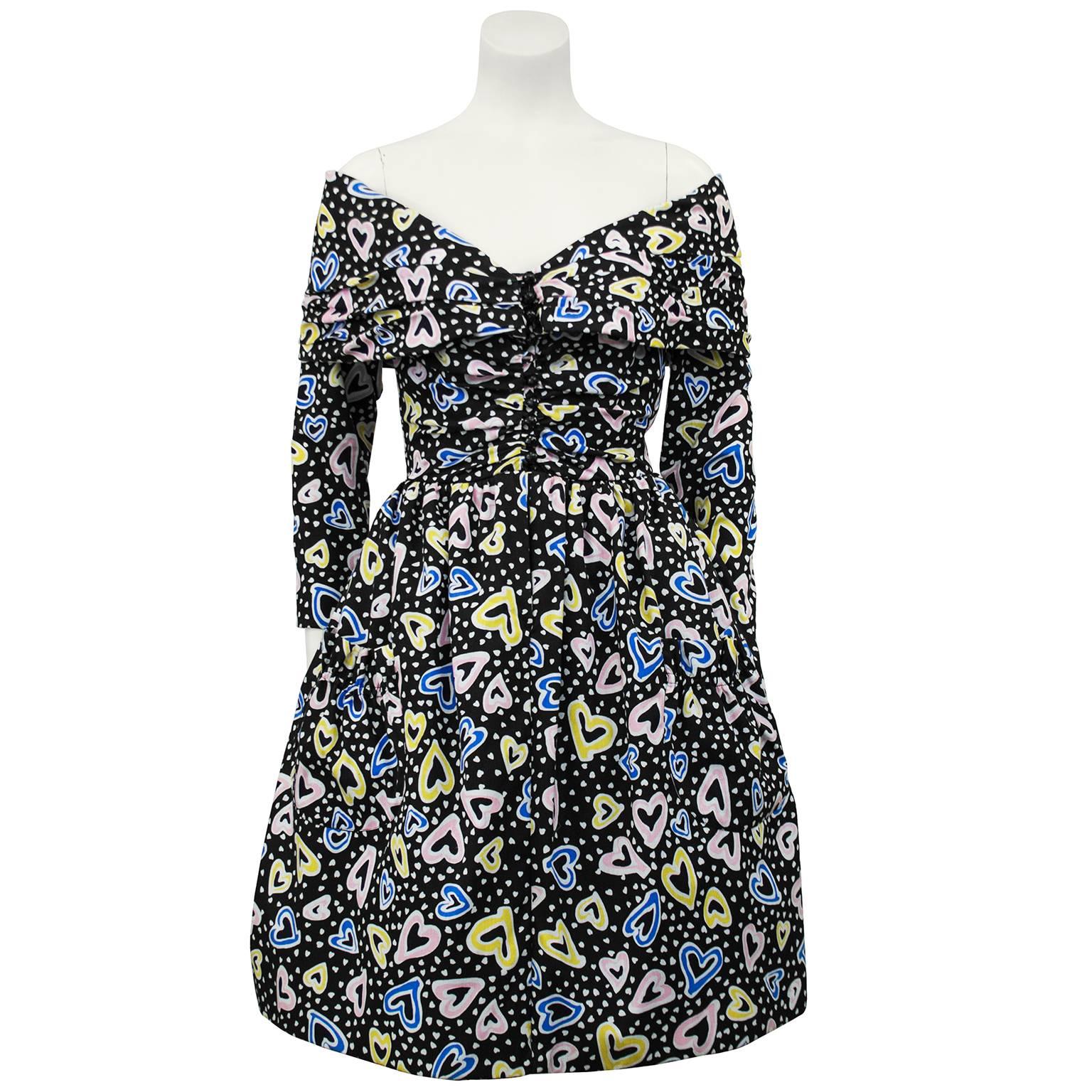 Keith Haring-esque printed 1980s Victor Costa cocktail dress with corset body in the style of Christian Lacroix. The dress has a hidden zipper up the front of the sweetheart neckline corset and the full length sleeves and off the shoulder wraps over