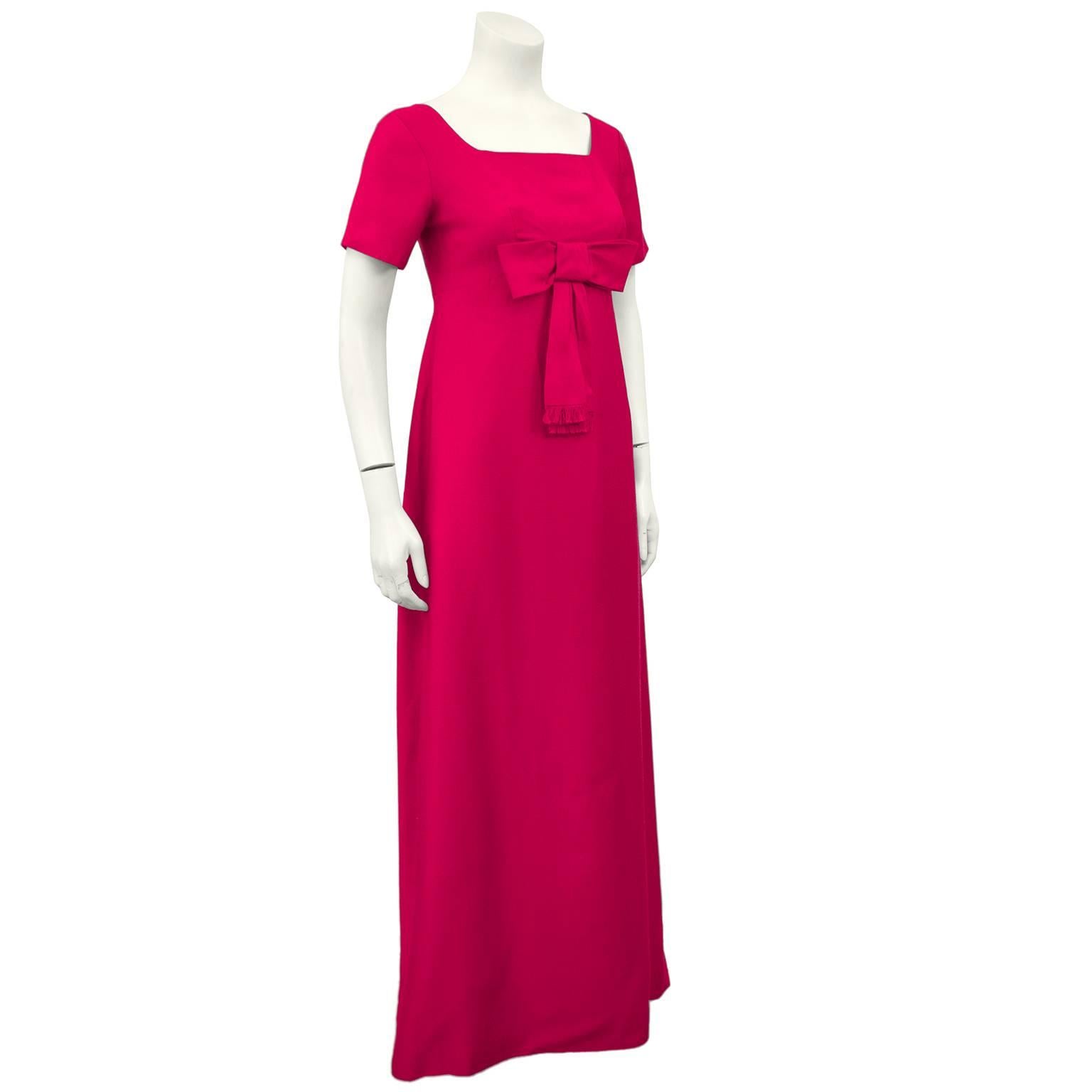 Gorgeous 1960s fuchsia gown with short sleeves, square neckline and a bow with raw edge at the empire bust. Zips up the back half way and snaps secure the rest. Faux buttons, in excellent unworn condition. Fits like a US 2-4.