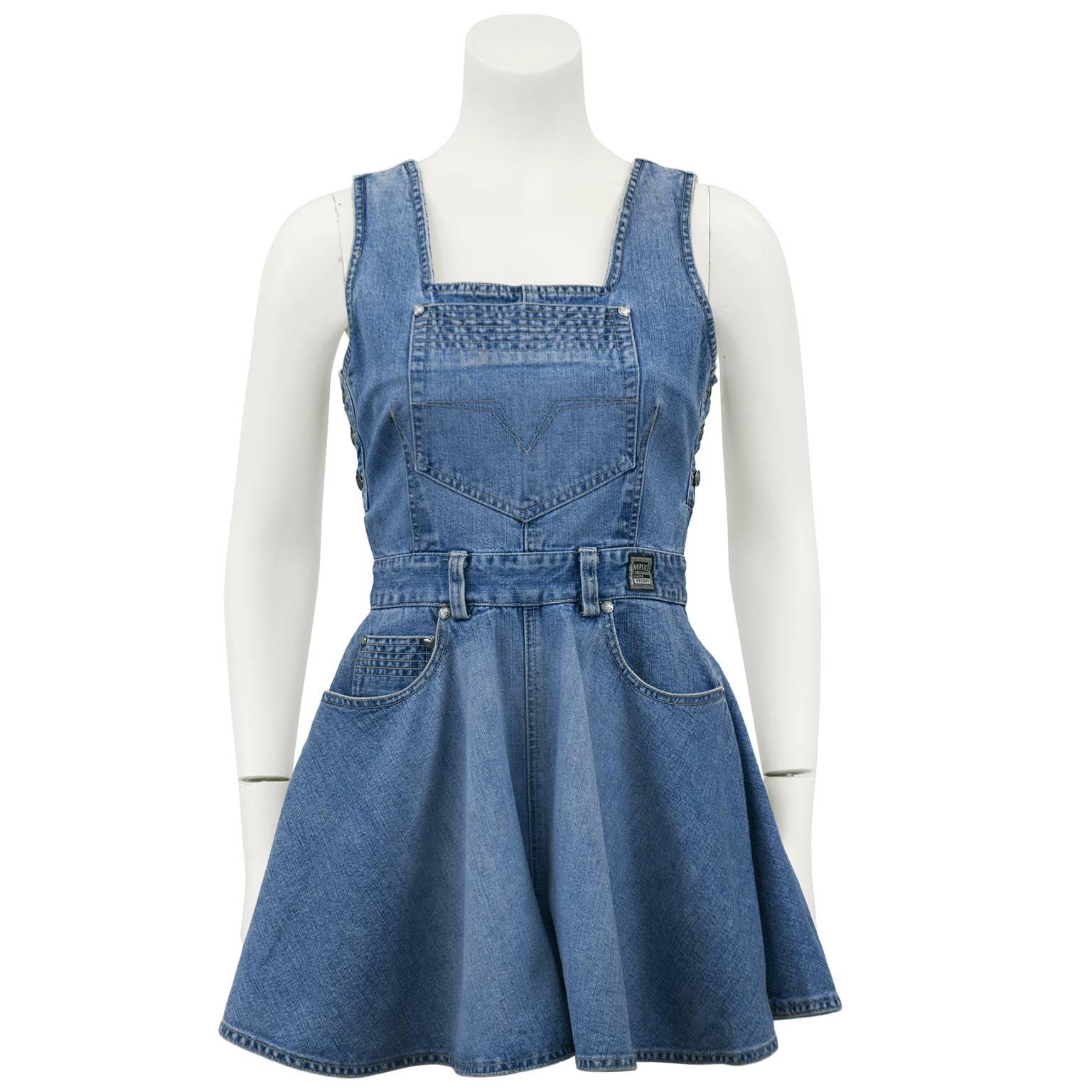 Adorable fit and flare style denim romper from the 1990s. The square neckline is complimented with a classic denim style over sized patch pocket on the bust and button panels down the sides. The waist is accented with belt loops and a Versace label.