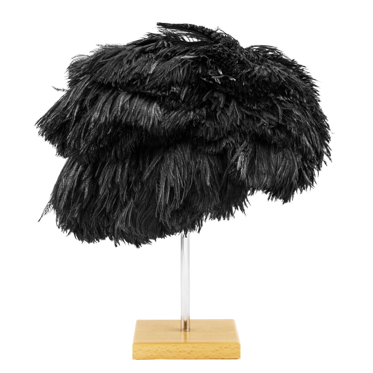 Light and fluttery while also dramatic, this beautiful hat designed by Yves Saint Laurent for Christian Dior-New York label from the 1950's is in immaculate condition. All the feather plumes are intact, the interior is clean and the comb is well