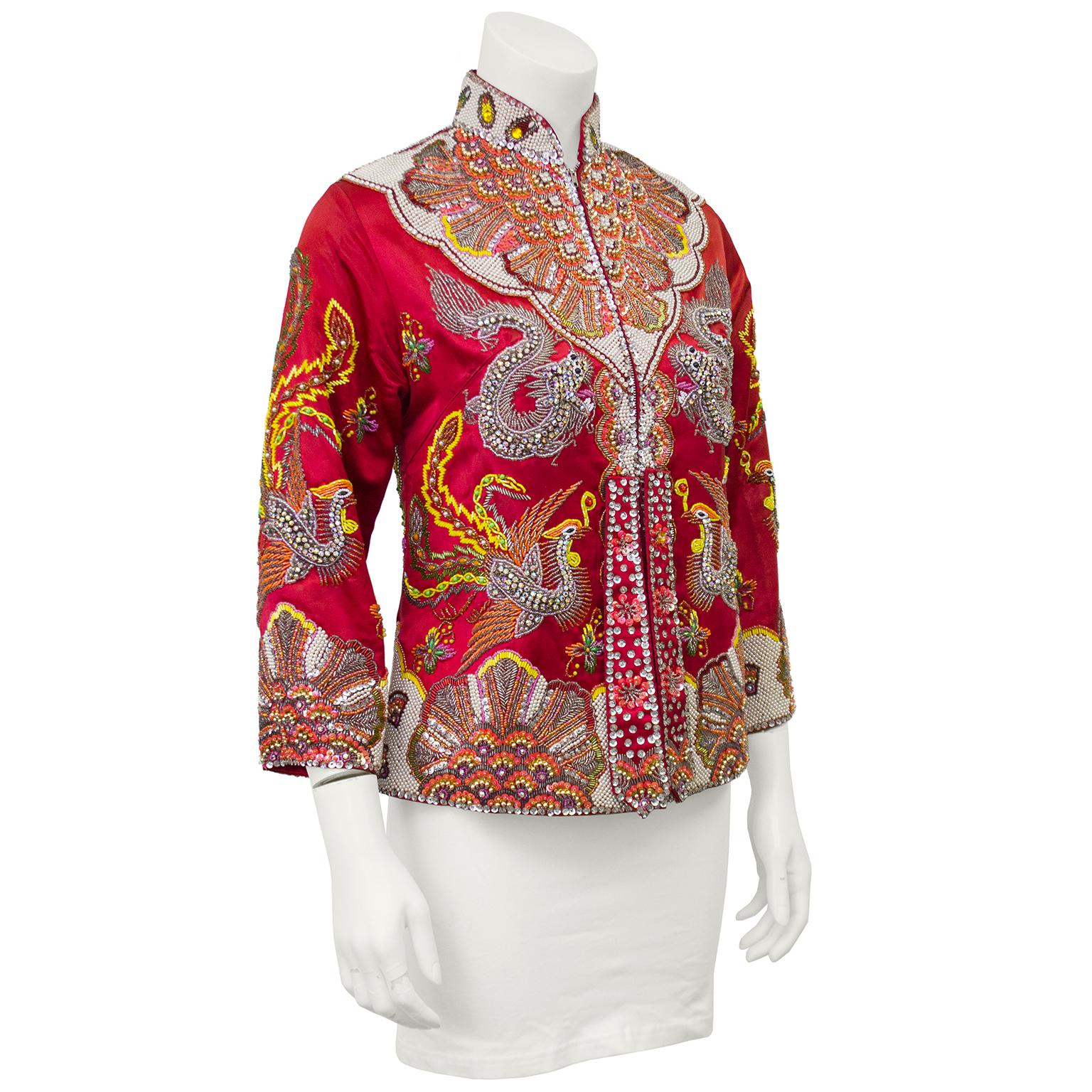 Over the top 1960's red satin hand beaded Mandarin collar evening jacket with two hanging tabs. Encrusted with sequins, rhinestones, pearls and hand embroidery this jacket is befitting an Empress! Metal zipper up the front, flaming dragons