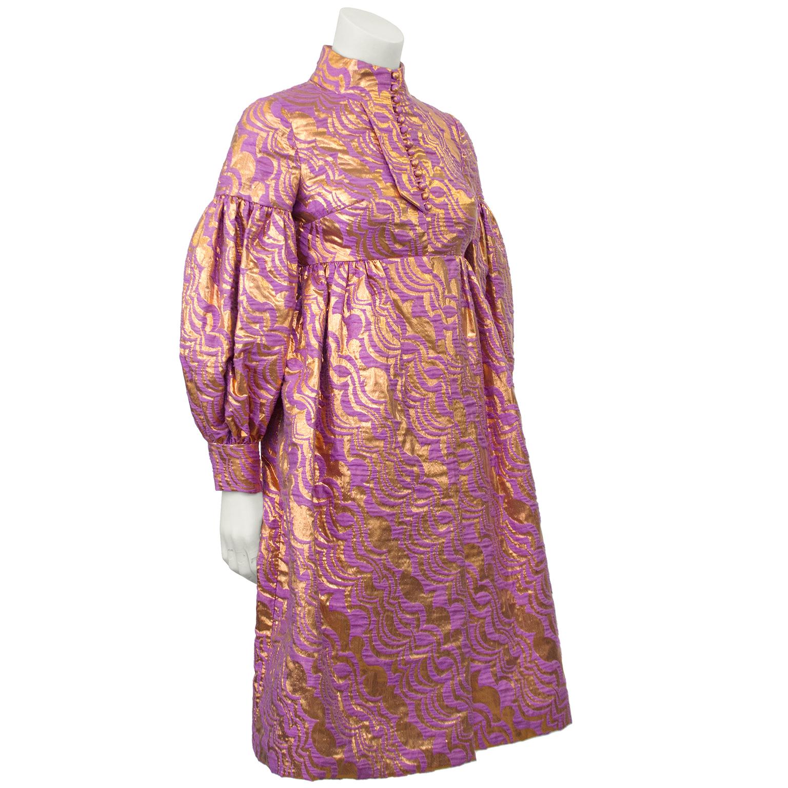 Anonymous, though very inspired by Geoffrey Beene, 1970's brocade baby doll dress in stunning combination of rose gold and lavender. Tiny covered buttons up the bodice from the empire waist, amd blossoming bishop sleeves with narrow fit cuffs. In