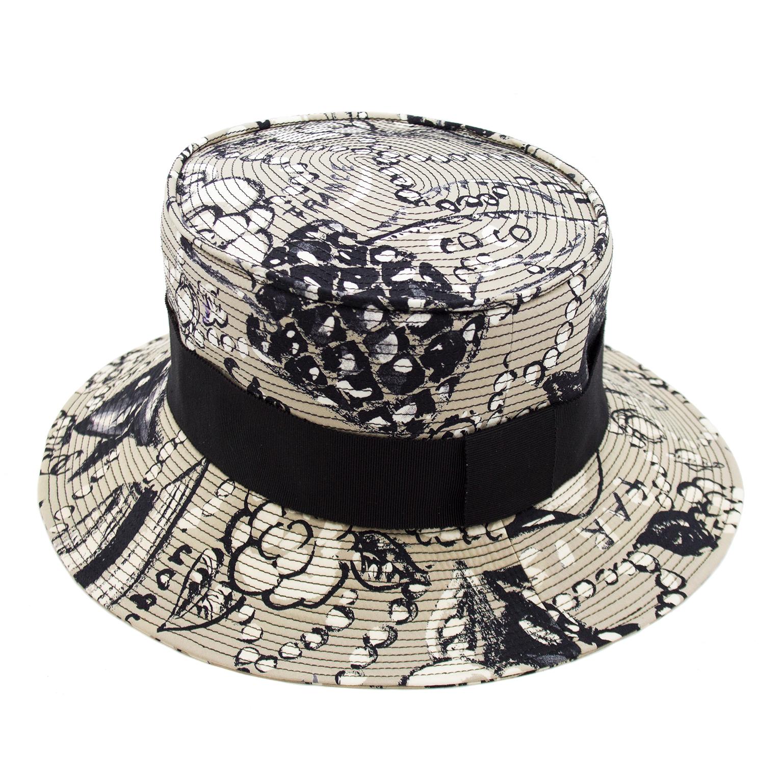 Taupe, white and black cotton flat top bucket hat with brim. Black grosgrain ribbon ties in with the hand drawn pearl, camelia and 255 quilted bag fabric. Fits quite small, 20 internal circumference. In excellent condition. Perfect for casual sun