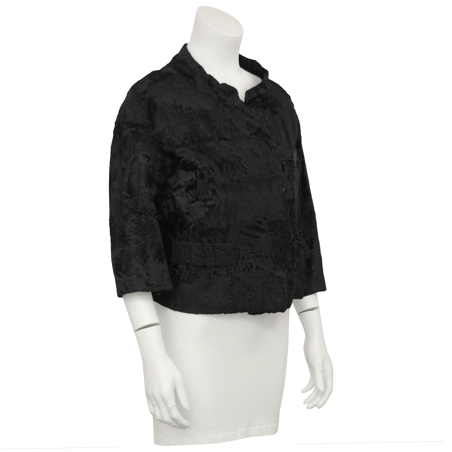 1960's Christian Dior Original for Holt Renfrew Canada black broadtail cropped jacket. High Mandarin style collar with overlapping hook closure and faux pocket patches on the front. Bracelet length sleeves.  Moderate wear to the edges of the sleeves