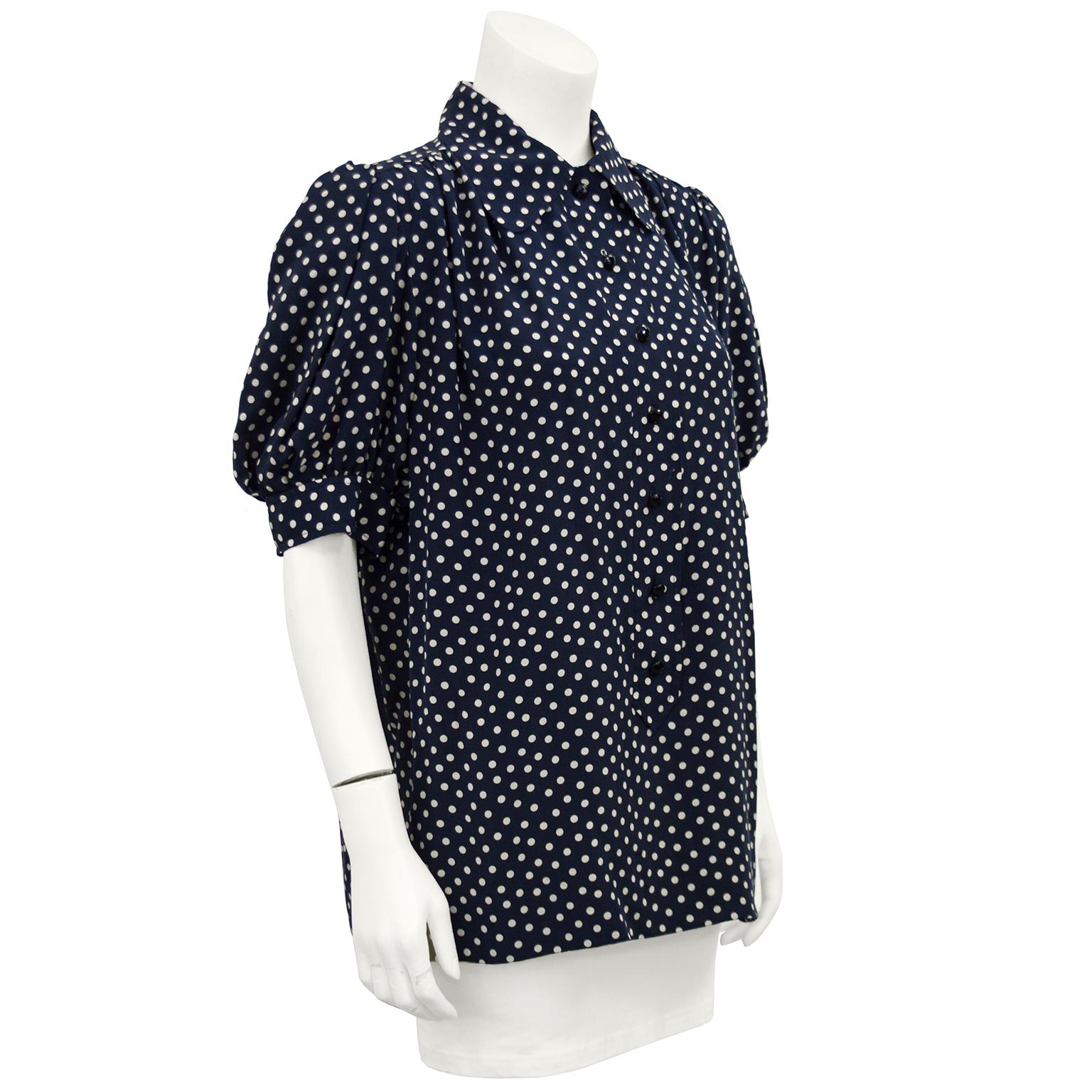 1980's YSL / Saint Laurent navy and white polka dot silk blouse with short gathered sleeve and slight gathering at the yoke. Very feminine fit button/placket front and gather at the shoulder. Full fit shape square across the bottom. Fits like a US
