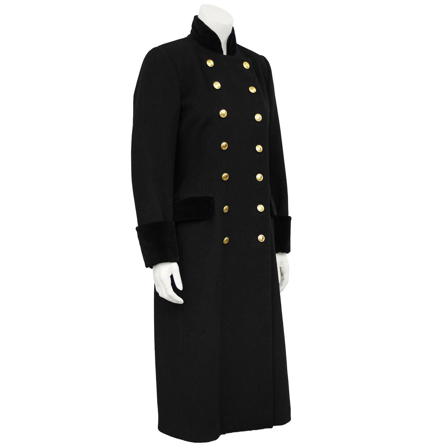 Christian Dior black military style coat from the 1980s. Black wool with black velvet cuffs, collar and pocket flaps. Double breasted with gold CD buttons. In excellent condition, fits like a US 4-6. 