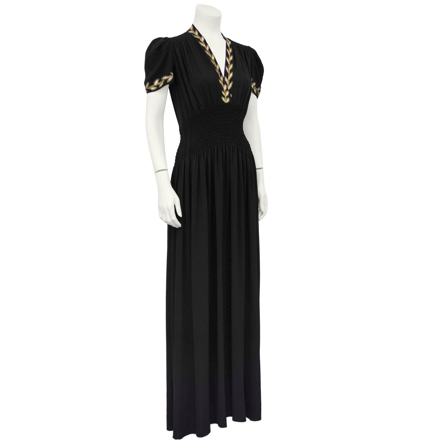 Timeless 1930's miss crepe and gold embroidered evening dress with slightly gathered shoulder and hand rouched wide waistline.  Elegant V neck and short sleeves are trimmed in hand sewn gold and white garland leaves. The fit of this silhouette is