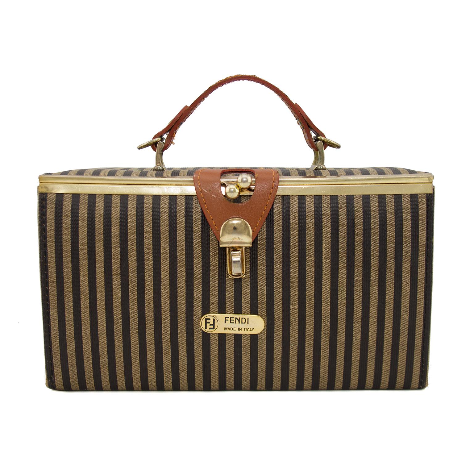 1980s Fendi Zucca striped rectangular 'Train Bag' with top handle and shoulder strap. The fresh and clean interior is lined in bright red corduroy with one interior side pocket and a large mirror on the underside of the top frame. Trimmed in gold