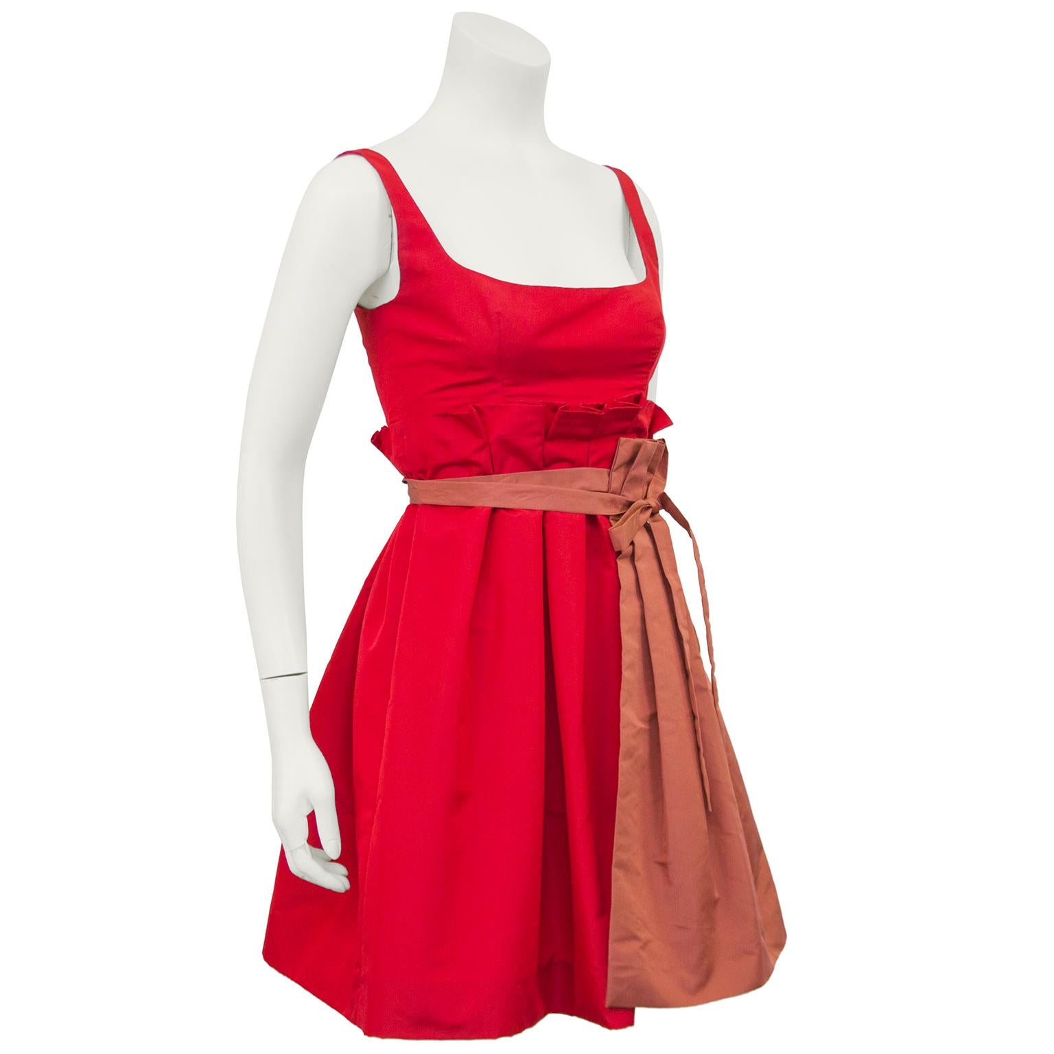 Babydoll style Prada bright red silk taffeta cocktail dress from the 2005 Spring ready-to-wear collection. The U shape bust line is meant to show off cleavage while the empire waistline keeps this dress fresh and young. Removable matching rust red