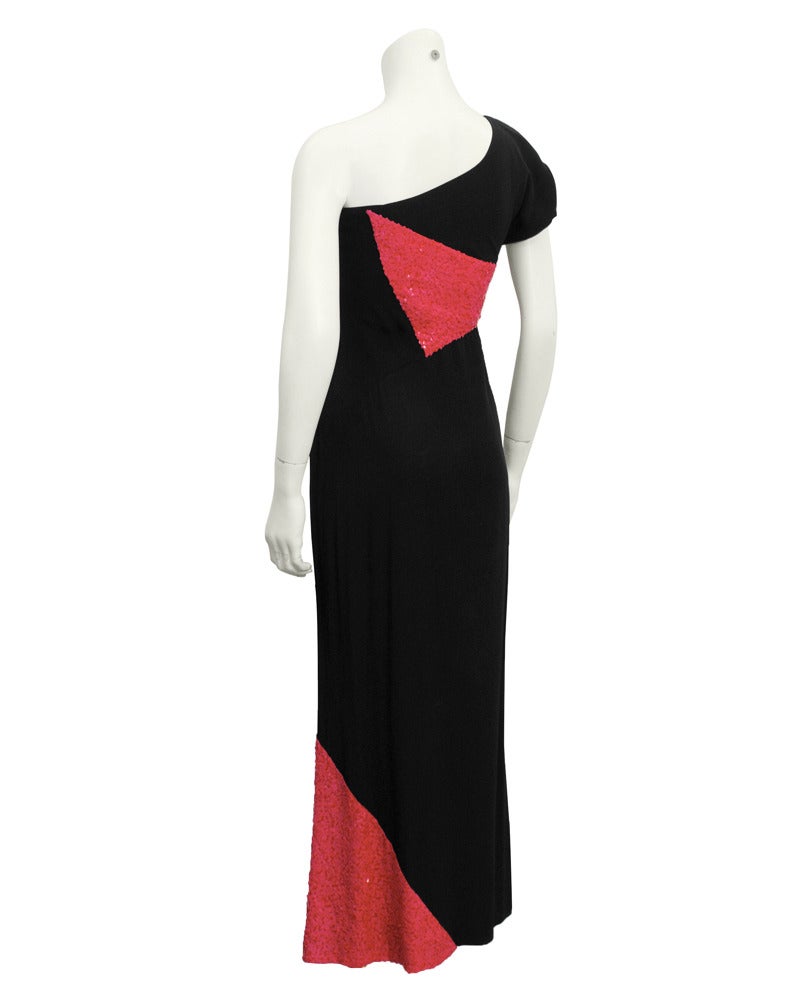 One sleeve, sexy Chloe gown from the 1970's, designed by Karl Lagerfeld. Inset panels of coral/pink sequins add an architectural feel to this dramatic black crepe evening dress. Zipper closure up left side when wearing. Excellent condition.