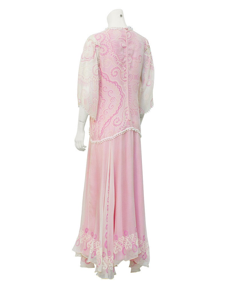 Quintessential circa 1980's Zandra Rhodes gown in a lovely pink and cream. The whole dress features beautiful hand painted designs with hand beaded faux pearls and rhinestones. The skirt is cream chiffon with a pink lining underneath. The neckline,
