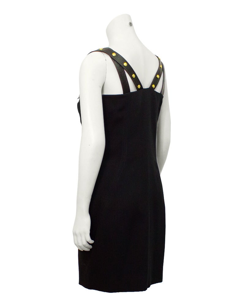 Early Versace for the label Istante, before he started his own fashion house. This bondage dress with leather shoulder straps, gold studs and silk sheath is an early sample of what Versace's design style would become. Iconic and collectible, and