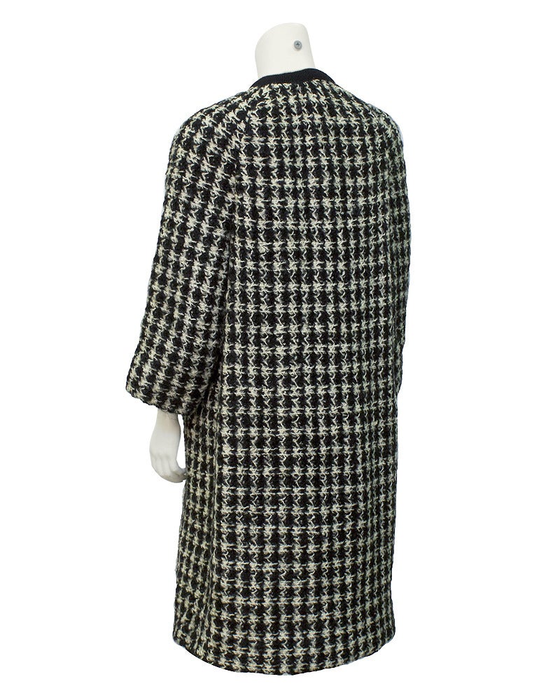 Stunning Jeanne Lanvin white and black tweed jacket circa 1965 with black and white knit trim around neck, down the front and on the front pockets. Unique brass colored metal buttons down front and on pockets are embellished with the head and