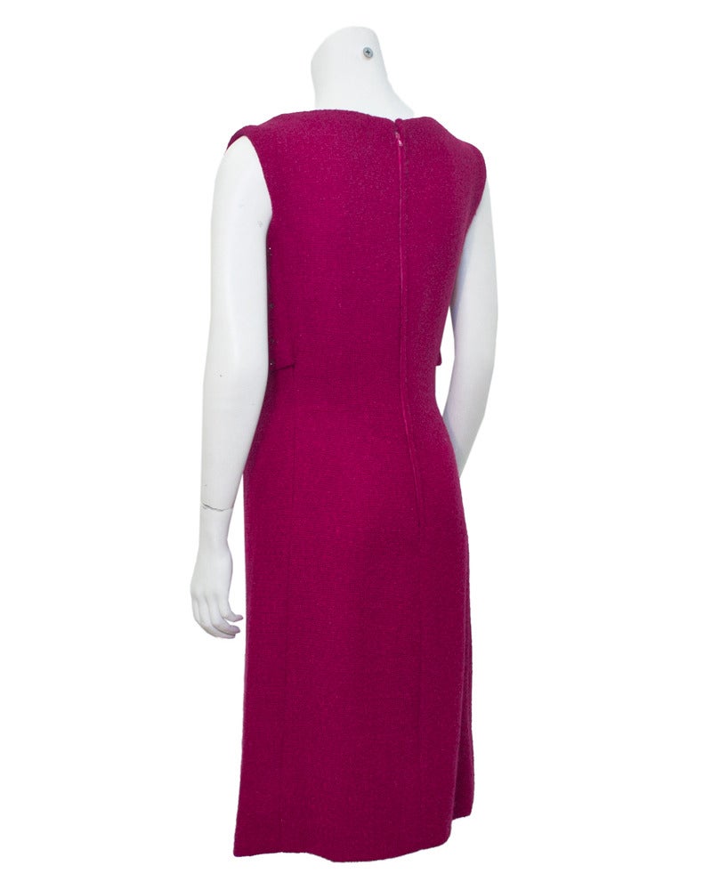 Famous for dressing glamorous stars, Sorelle Fontana dresses are unique and colorful. This fuchsia early 1960s sleeveless cocktail dress is made from a very delicate boucle with an attached vest on the bodice. The draping beads cascade down the