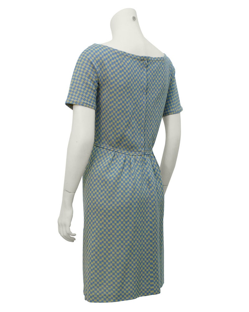 1960's Harmon Knitwear for Rudi Gernreich baby doll style dress in pale blue and tan check. Deep v neck is offset by modern overstitching. The style of the dress looks very current, condition excellent. Gernreich dresses are timeless and a great