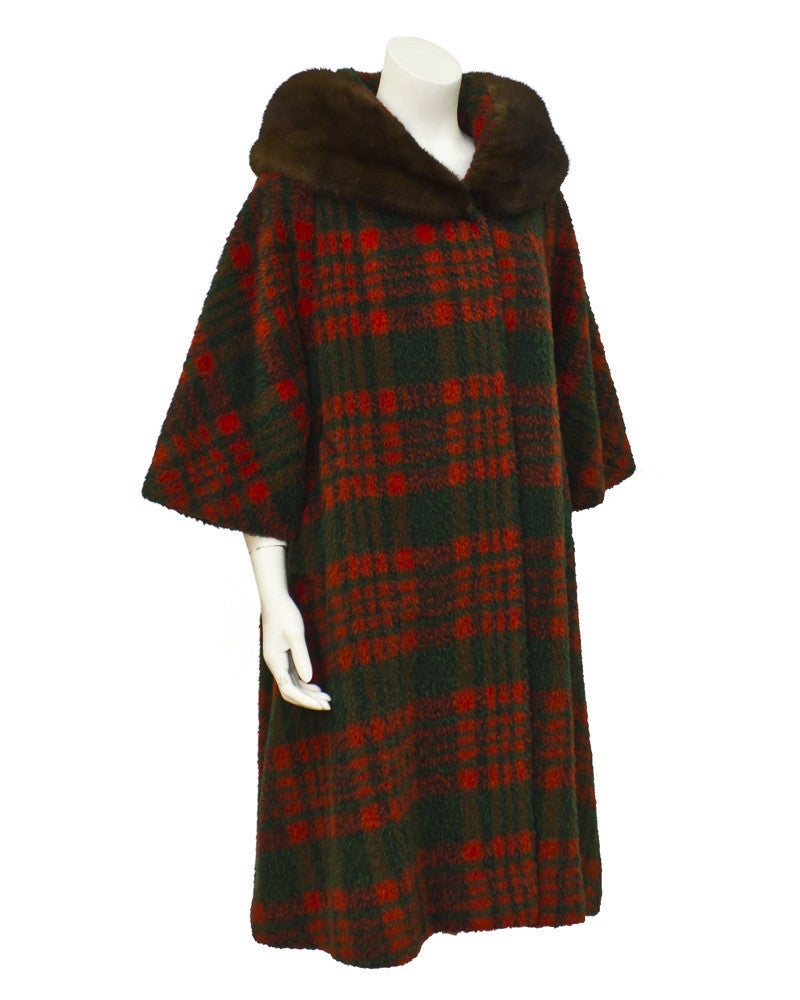 From the early 1960s, this wool Tisse a Paris for Lilli Ann coat is the perfect coat for fall. The cozy tartan coat is cut in a forgiving swing style and the fur (mink) collar adds drama and warmth. Bracelet length sleeves allows you to show off a