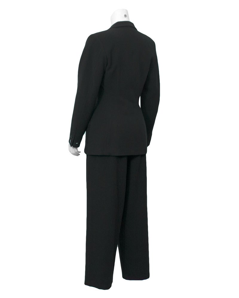 Very chic Yohji Yamamoto power suit from the 1980s. The long fitted blazer is double breasted and has black net patch pockets on the front at the hips. The pants are high waisted and wide leg style. Great worn together or separately. In excellent