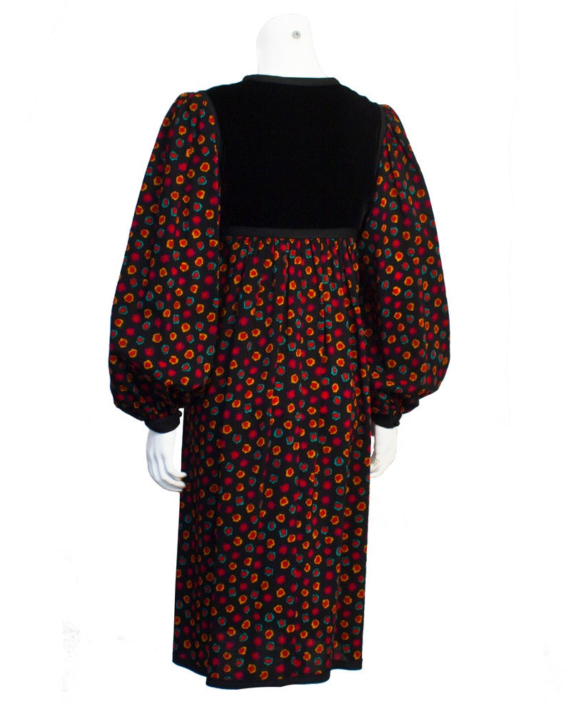 Very sweet Yves Saint Laurent baby doll-esque Rive Gauche dress from the late 1970's. Made out of jet black velvet and an abstract floral print, this dress would look amazing with knee high boots and tights for the fall. The black velvet yoke is