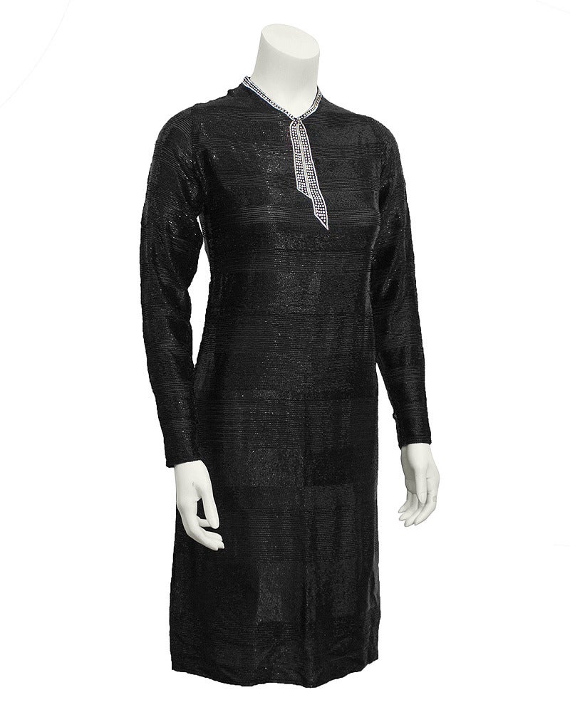 Stunning 1930's hand beaded long sleeve cocktail dress. Beading creates black on black horizontal stripes that get larger as they cascade towards the bottom of the dress. Neckline features beautiful silver and rhinestone tromp l'oeil beading in the