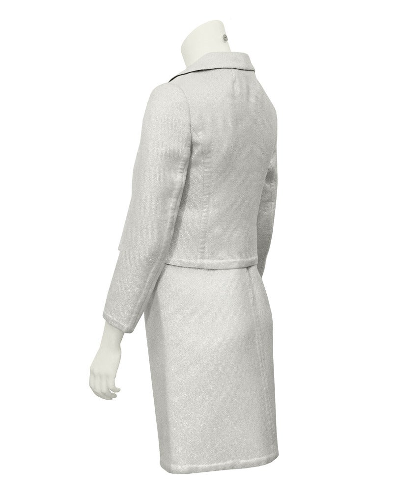 Hard to find Italian made1960's Fabiani ensemble featuring a silver lurex embedded wool cropped jacket with a peter pan collar and three fabric covered buttons down the front. The dress is sleeveless, empire waist with sequin and beaded
